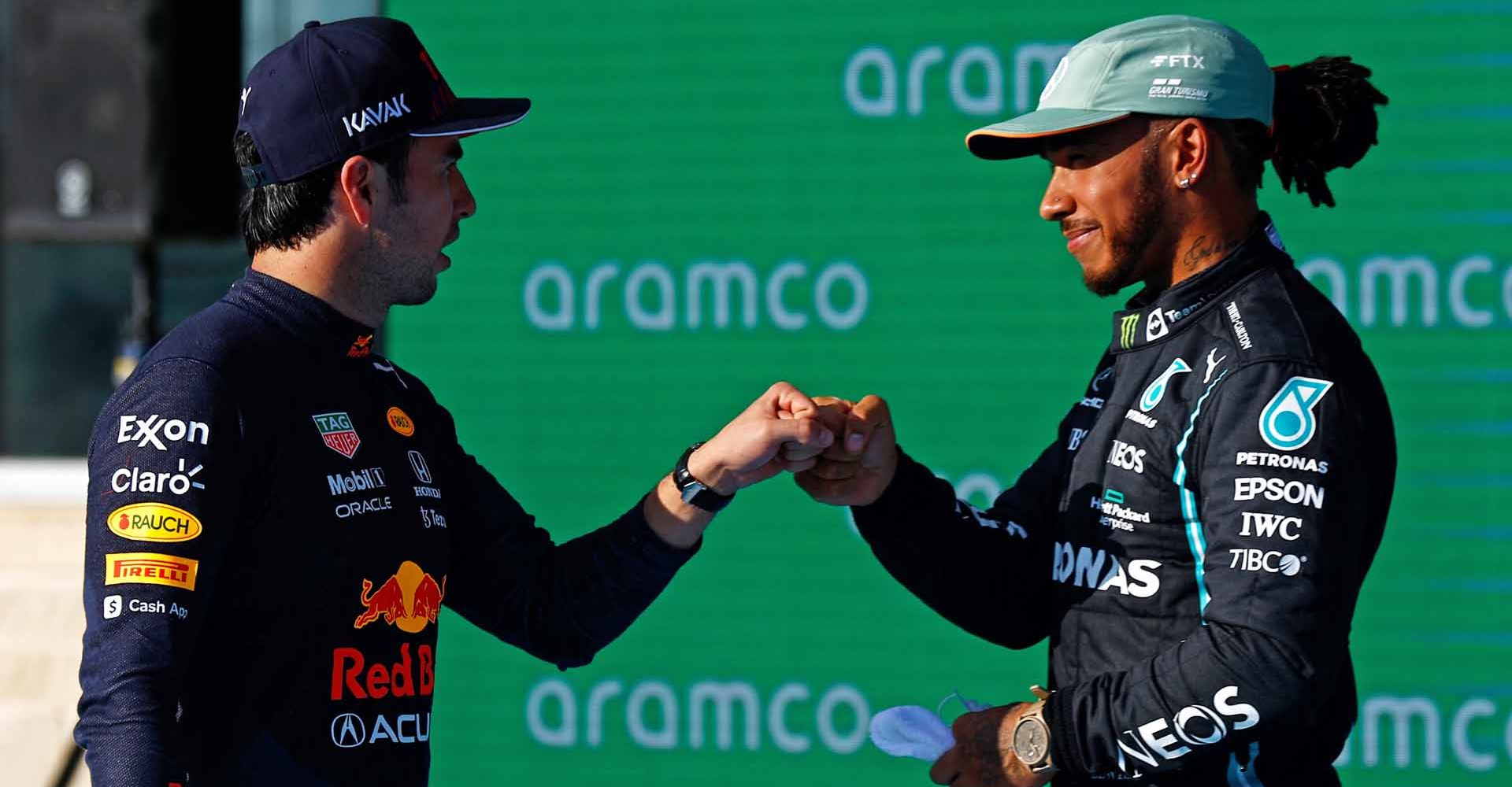 AUSTIN, TEXAS - OCTOBER 23: Second place qualifier Lewis Hamilton of Great Britain and Mercedes GP and third place qualifier Sergio Perez of Mexico and Red Bull Racing celebrate in parc ferme during qualifying ahead of the F1 Grand Prix of USA at Circuit of The Americas on October 23, 2021 in Austin, Texas. (Photo by Jared C. Tilton/Getty Images)