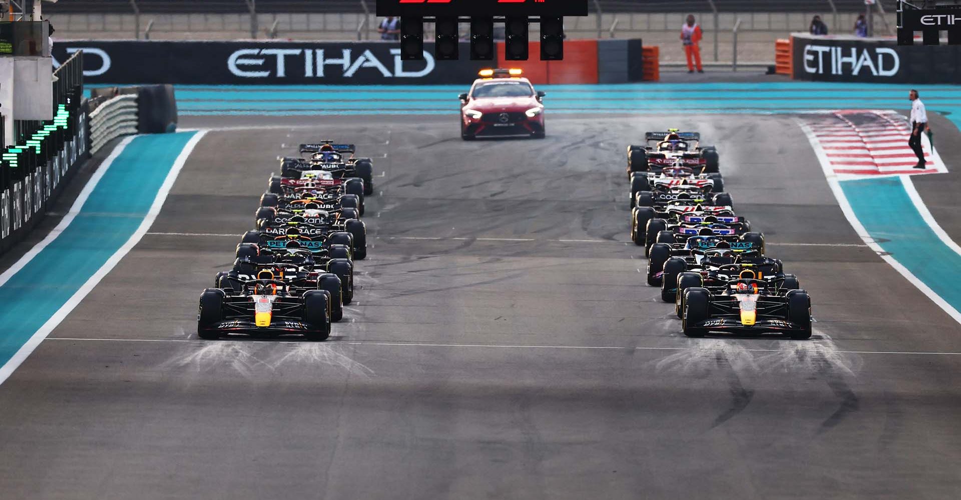 ABU DHABI, UNITED ARAB EMIRATES - NOVEMBER 20: Max Verstappen of the Netherlands driving the (1) Oracle Red Bull Racing RB18 and Sergio Perez of Mexico driving the (11) Oracle Red Bull Racing RB18 head the field as they prepare for the start during the F1 Grand Prix of Abu Dhabi at Yas Marina Circuit on November 20, 2022 in Abu Dhabi, United Arab Emirates. (Photo by Mark Thompson/Getty Images)