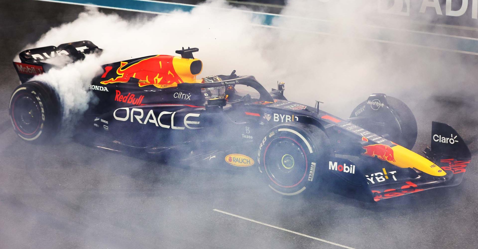 ABU DHABI, UNITED ARAB EMIRATES - NOVEMBER 20: Race winner Max Verstappen of the Netherlands driving the (1) Oracle Red Bull Racing RB18 performs a celebratory donut during the F1 Grand Prix of Abu Dhabi at Yas Marina Circuit on November 20, 2022 in Abu Dhabi, United Arab Emirates. (Photo by Mark Thompson/Getty Images)