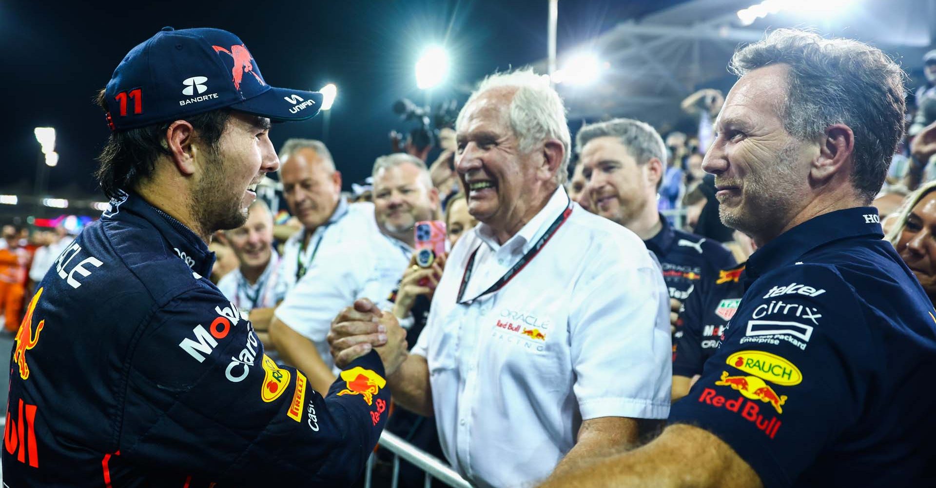 ABU DHABI, UNITED ARAB EMIRATES - NOVEMBER 20: Third placed Sergio Perez of Mexico and Oracle Red Bull Racing celebrates with Red Bull Racing Team Consultant Dr Helmut Marko and Red Bull Racing Team Principal Christian Horner in parc ferme during the F1 Grand Prix of Abu Dhabi at Yas Marina Circuit on November 20, 2022 in Abu Dhabi, United Arab Emirates. (Photo by Mark Thompson/Getty Images)