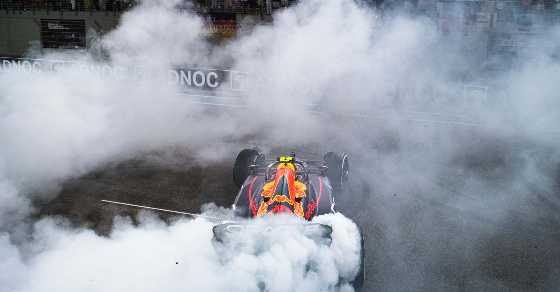 ABU DHABI, UNITED ARAB EMIRATES - NOVEMBER 20: Third placed Sergio Perez of Mexico and Oracle Red Bull Racing performs a celebratory donut during the F1 Grand Prix of Abu Dhabi at Yas Marina Circuit on November 20, 2022 in Abu Dhabi, United Arab Emirates. (Photo by Rudy Carezzevoli/Getty Images)