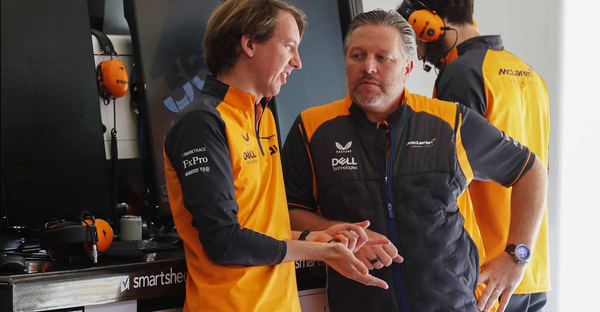 Zak Brown, CEO, McLaren Racing, talks to an engineer in the garage