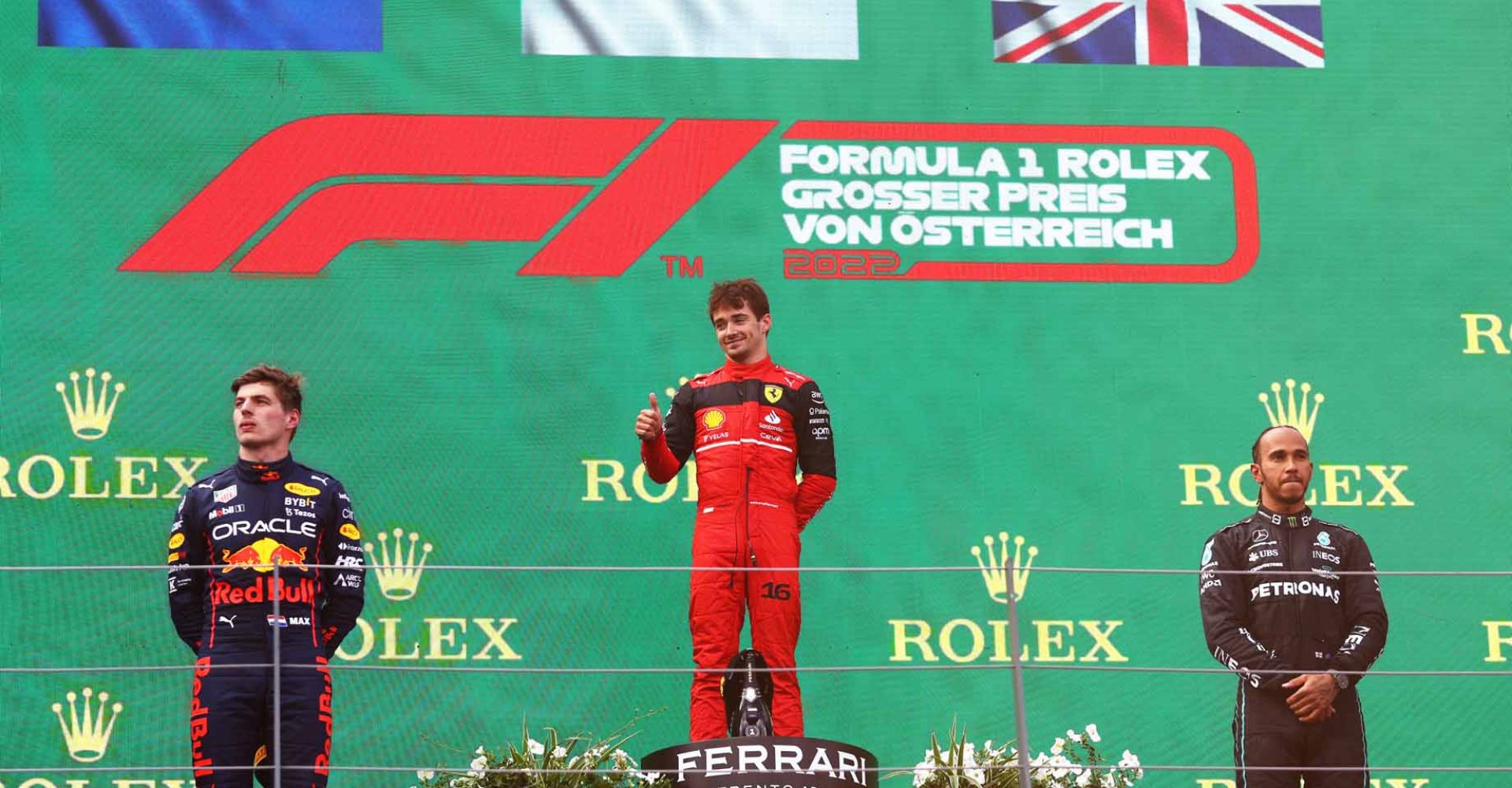 SPIELBERG, AUSTRIA - JULY 10: Race winner Charles Leclerc of Monaco and Ferrari (C), Second placed Max Verstappen of the Netherlands and Oracle Red Bull Racing (L) and Third placed Lewis Hamilton of Great Britain and Mercedes (R) celebrate on the podium during the F1 Grand Prix of Austria at Red Bull Ring on July 10, 2022 in Spielberg, Austria. (Photo by Clive Rose/Getty Images)