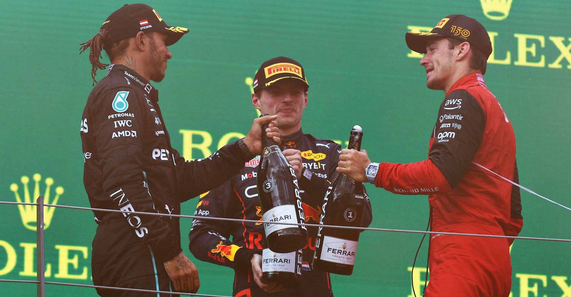 SPIELBERG, AUSTRIA - JULY 10: Race winner Charles Leclerc of Monaco and Ferrari, Second placed Max Verstappen of the Netherlands and Oracle Red Bull Racing and Third placed Lewis Hamilton of Great Britain and Mercedes celebrate on the podium during the F1 Grand Prix of Austria at Red Bull Ring on July 10, 2022 in Spielberg, Austria. (Photo by Clive Rose/Getty Images)