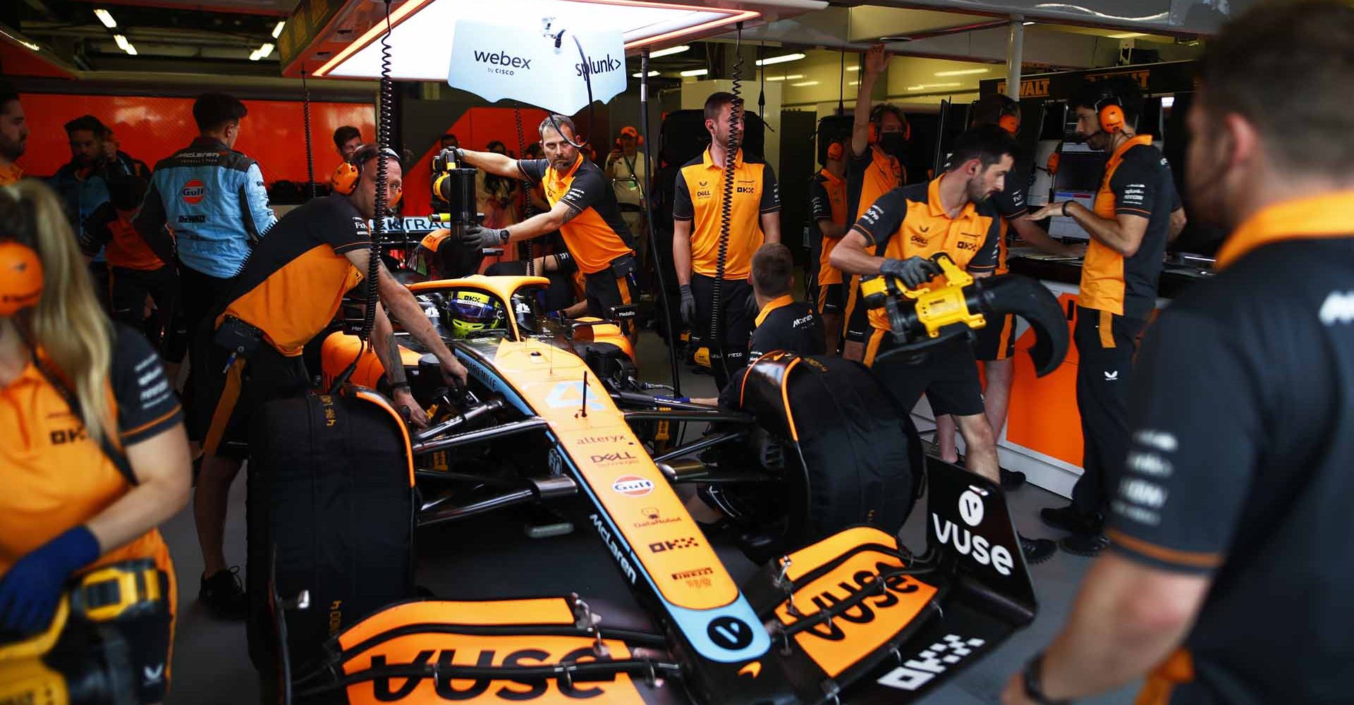 Lando Norris, McLaren MCL36, in the garage with mechanics