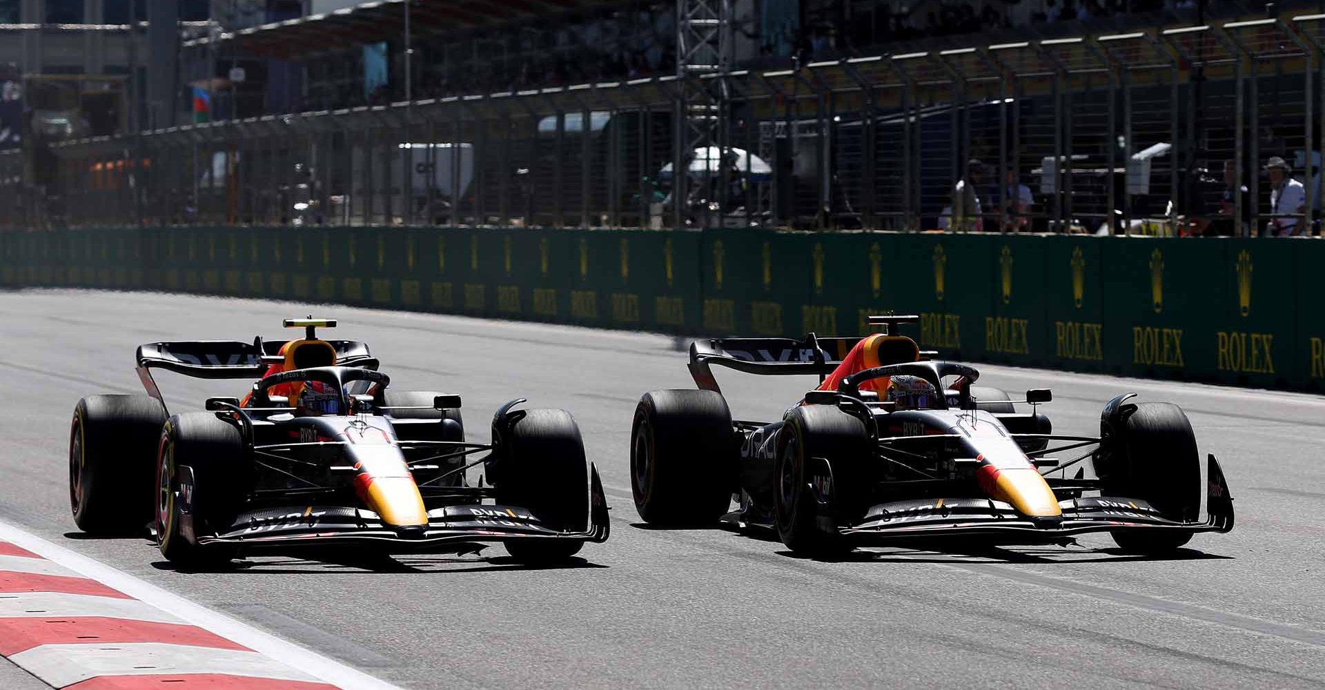 BAKU, AZERBAIJAN - JUNE 12: Max Verstappen of the Netherlands driving the (1) Oracle Red Bull Racing RB18 overtakes Sergio Perez of Mexico driving the (11) Oracle Red Bull Racing RB18 for the lead during the F1 Grand Prix of Azerbaijan at Baku City Circuit on June 12, 2022 in Baku, Azerbaijan. (Photo by Peter Fox/Getty Images)