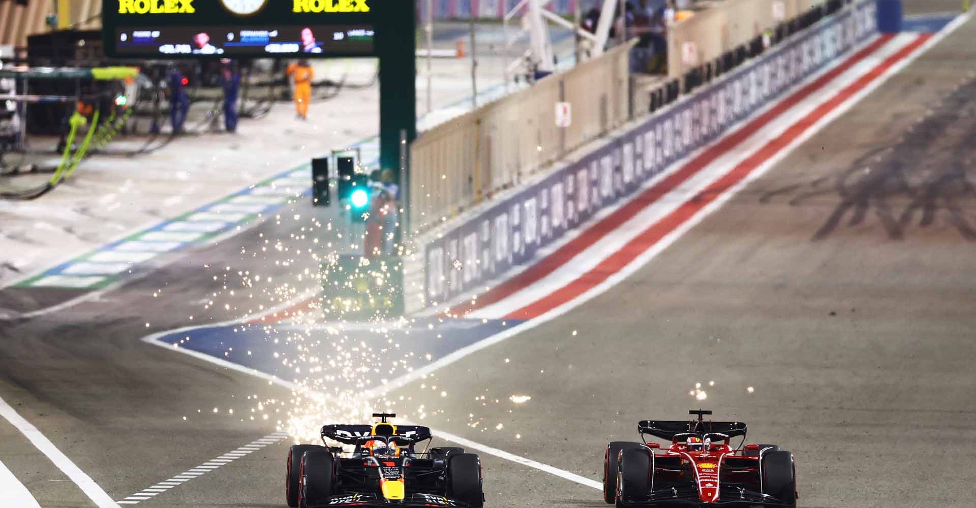 BAHRAIN, BAHRAIN - MARCH 20: Max Verstappen of the Netherlands driving the (1) Oracle Red Bull Racing RB18 overtakes Charles Leclerc of Monaco driving (16) the Ferrari F1-75 into turn one during the F1 Grand Prix of Bahrain at Bahrain International Circuit on March 20, 2022 in Bahrain, Bahrain. (Photo by Mark Thompson/Getty Images)