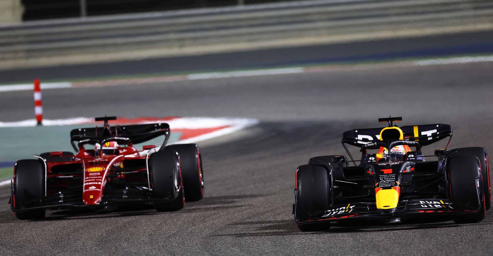 BAHRAIN, BAHRAIN - MARCH 20: Max Verstappen of the Netherlands driving the (1) Oracle Red Bull Racing RB18 and Charles Leclerc of Monaco driving (16) the Ferrari F1-75 battle for track position during the F1 Grand Prix of Bahrain at Bahrain International Circuit on March 20, 2022 in Bahrain, Bahrain. (Photo by Lars Baron/Getty Images)