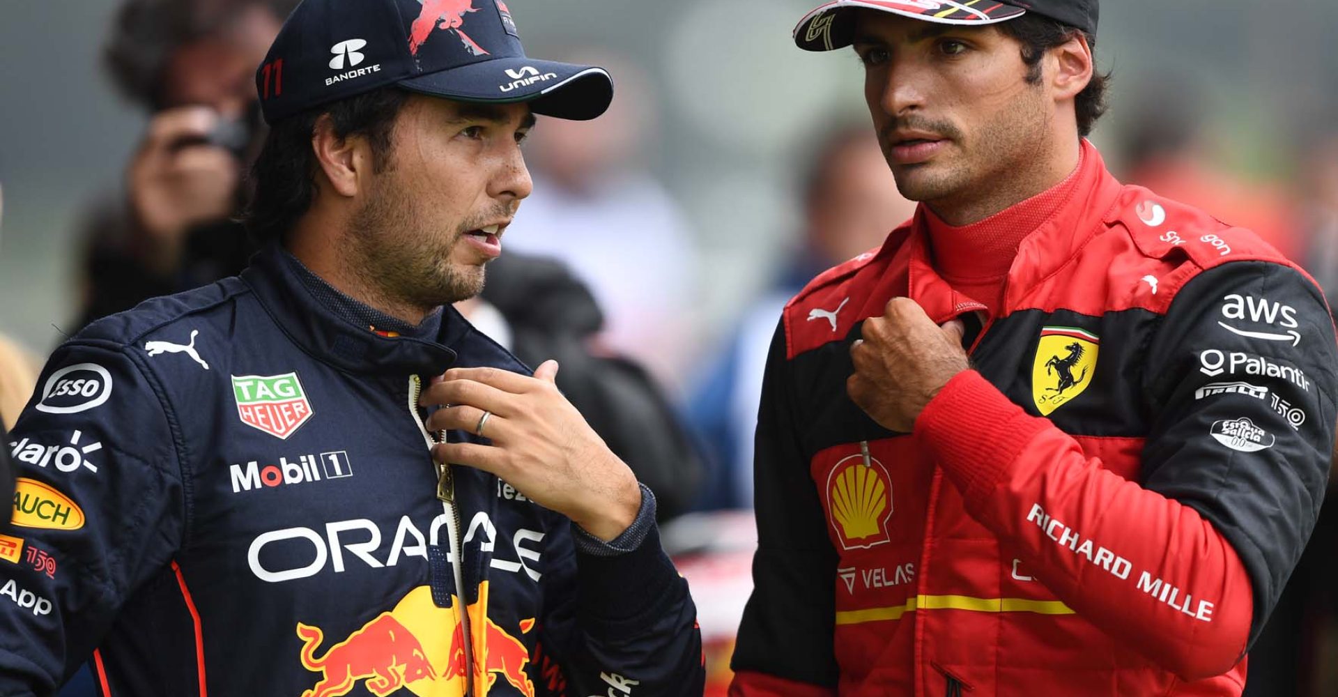 SPA, BELGIUM - AUGUST 27: Second placed qualifier Carlos Sainz of Spain and Ferrari and Third placed qualifier Sergio Perez of Mexico and Oracle Red Bull Racing talk in parc ferme during qualifying ahead of the F1 Grand Prix of Belgium at Circuit de Spa-Francorchamps on August 27, 2022 in Spa, Belgium. (Photo by Rudy Carezzevoli/Getty Images)