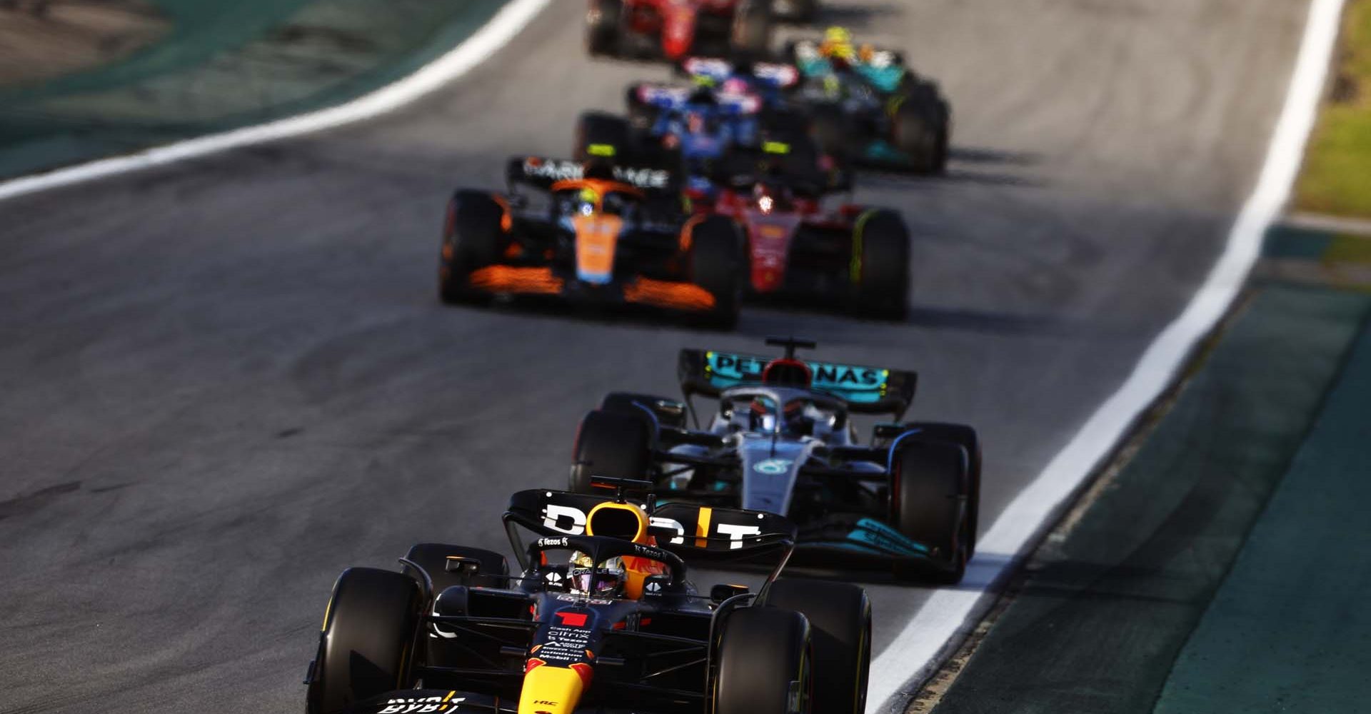 SAO PAULO, BRAZIL - NOVEMBER 12: Max Verstappen of the Netherlands driving the (1) Oracle Red Bull Racing RB18 leads George Russell of Great Britain driving the (63) Mercedes AMG Petronas F1 Team W13 during the Sprint ahead of the F1 Grand Prix of Brazil at Autodromo Jose Carlos Pace on November 12, 2022 in Sao Paulo, Brazil. (Photo by Chris Graythen/Getty Images)