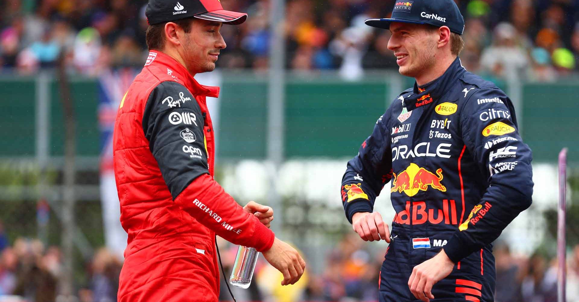 NORTHAMPTON, ENGLAND - JULY 02: Third placed qualifier Charles Leclerc of Monaco and Ferrari and Second placed qualifier Max Verstappen of the Netherlands and Oracle Red Bull Racing talk in parc ferme during qualifying ahead of the F1 Grand Prix of Great Britain at Silverstone on July 02, 2022 in Northampton, England. (Photo by Mark Thompson/Getty Images)