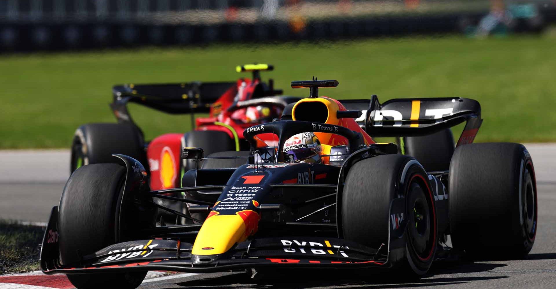 MONTREAL, QUEBEC - JUNE 19: Max Verstappen of the Netherlands driving the (1) Oracle Red Bull Racing RB18 leads Carlos Sainz of Spain driving (55) the Ferrari F1-75 during the F1 Grand Prix of Canada at Circuit Gilles Villeneuve on June 19, 2022 in Montreal, Quebec. (Photo by Peter Fox/Getty Images)