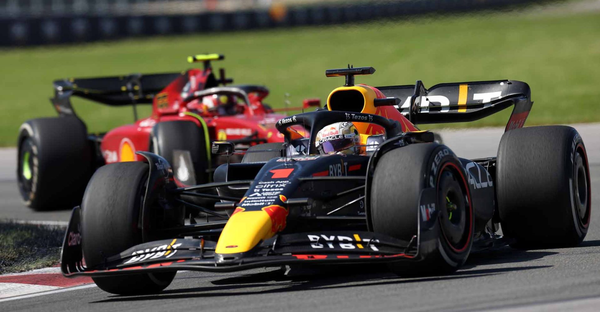 MONTREAL, QUEBEC - JUNE 19: Max Verstappen of the Netherlands driving the (1) Oracle Red Bull Racing RB18 leads Carlos Sainz of Spain driving (55) the Ferrari F1-75 during the F1 Grand Prix of Canada at Circuit Gilles Villeneuve on June 19, 2022 in Montreal, Quebec. (Photo by Peter Fox/Getty Images)