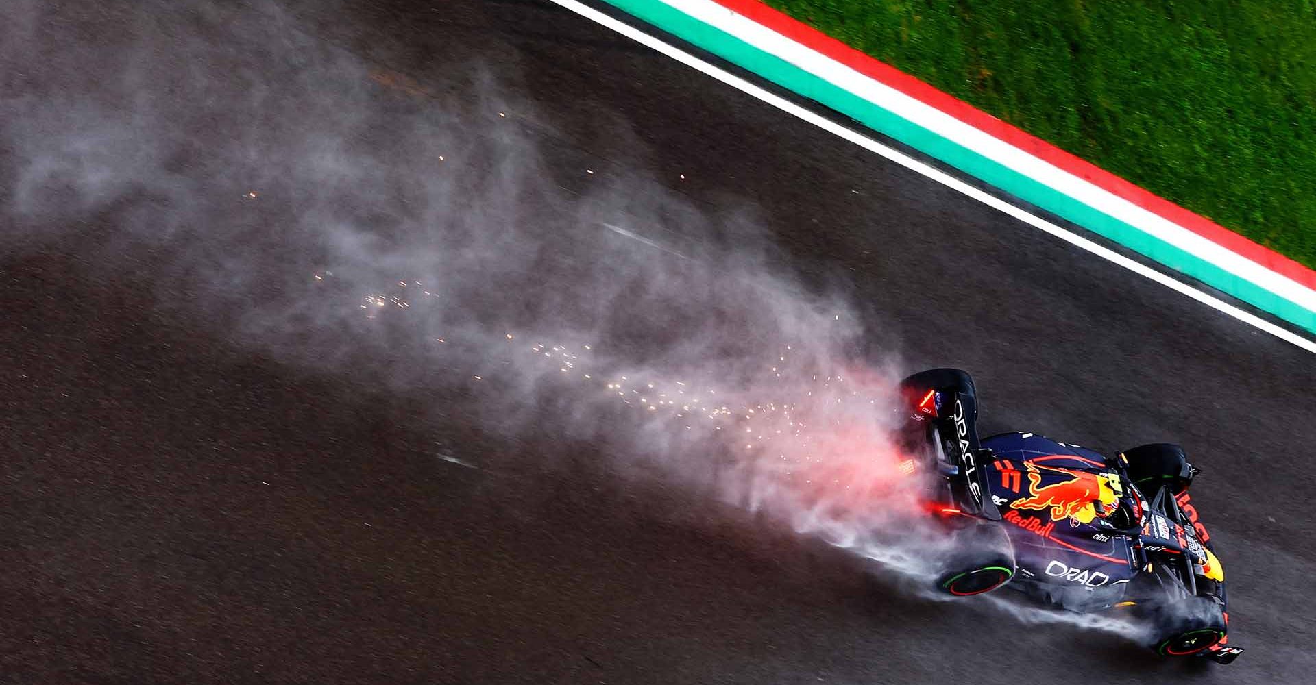 IMOLA, ITALY - APRIL 22: Sparks and water spray behind Sergio Perez of Mexico driving the (11) Oracle Red Bull Racing RB18 on track during practice ahead of the F1 Grand Prix of Emilia Romagna at Autodromo Enzo e Dino Ferrari on April 22, 2022 in Imola, Italy. (Photo by Mark Thompson/Getty Images)