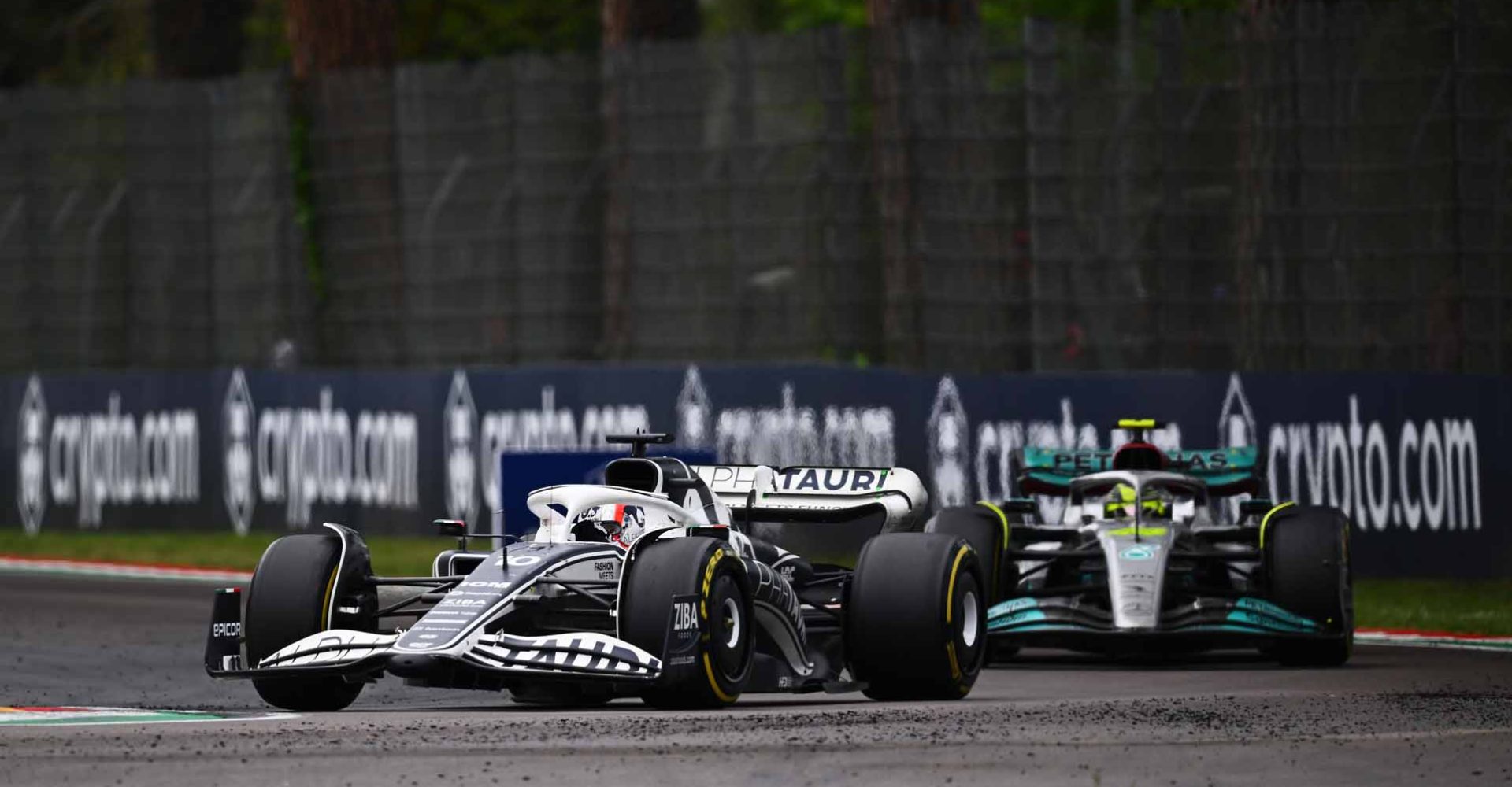 IMOLA, ITALY - APRIL 24: Pierre Gasly of France driving the (10) Scuderia AlphaTauri AT03 leads Lewis Hamilton of Great Britain driving the (44) Mercedes AMG Petronas F1 Team W13 during the F1 Grand Prix of Emilia Romagna at Autodromo Enzo e Dino Ferrari on April 24, 2022 in Imola, Italy. (Photo by Clive Mason/Getty Images)