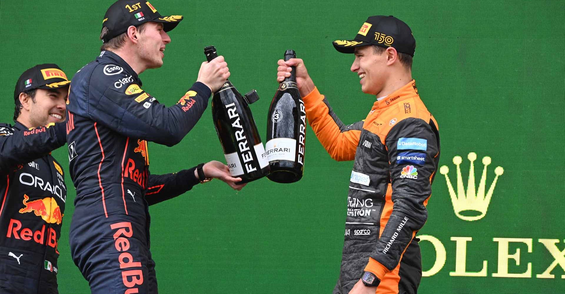 Max Verstappen, Red Bull Racing, 1st position, and Lando Norris, McLaren, 3rd position, celebrate with Champagne on the podium