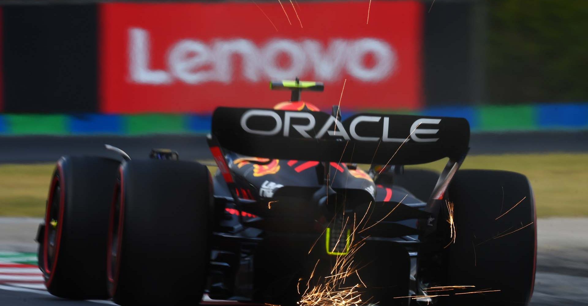 BUDAPEST, HUNGARY - JULY 29: Sparks fly behind Sergio Perez of Mexico driving the (11) Oracle Red Bull Racing RB18 on track during practice ahead of the F1 Grand Prix of Hungary at Hungaroring on July 29, 2022 in Budapest, Hungary. (Photo by Dan Mullan/Getty Images)