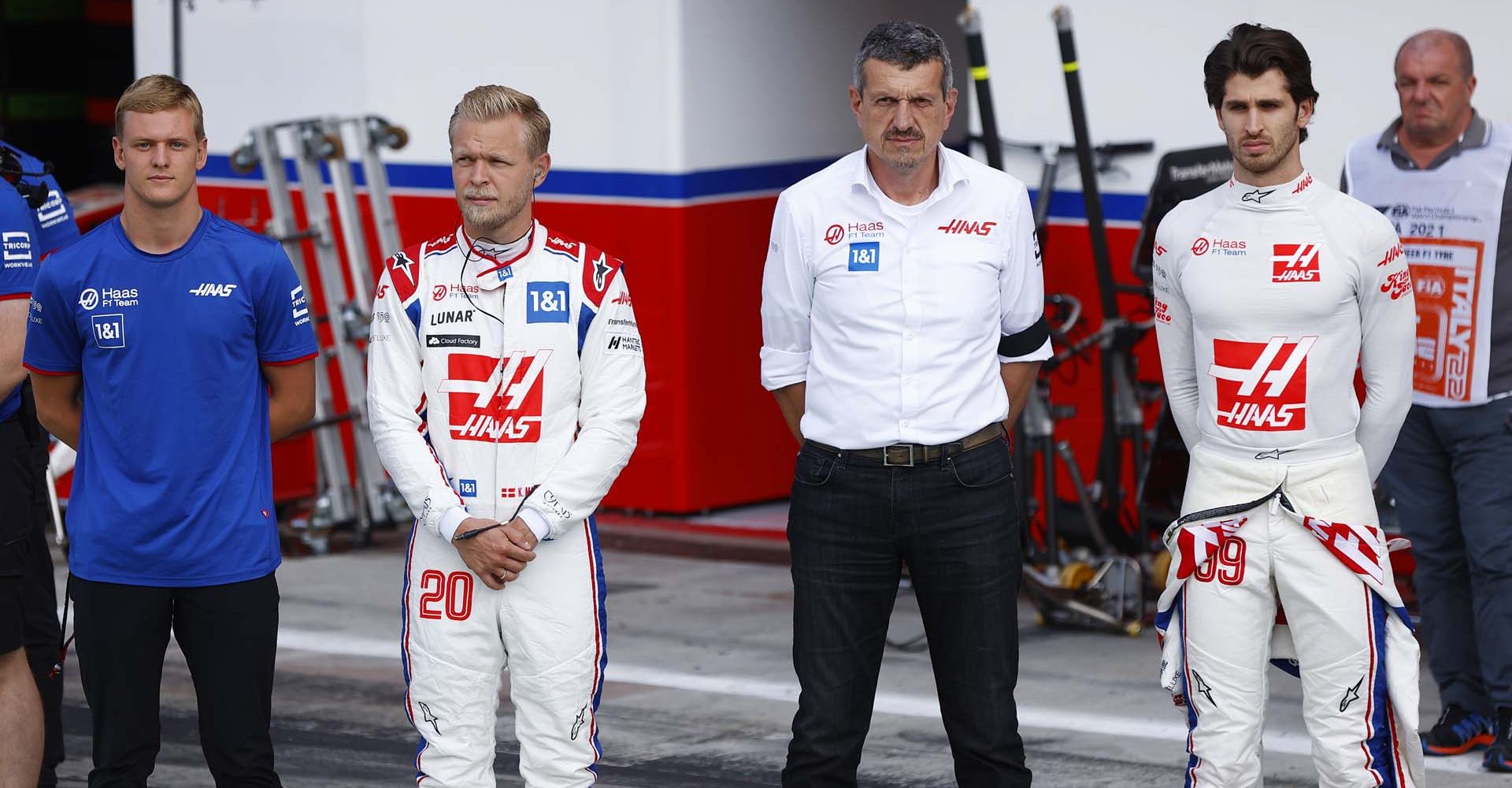 AUTODROMO NAZIONALE MONZA, ITALY - SEPTEMBER 09: Mick Schumacher, Haas F1 Team, Kevin Magnussen, Haas F1 Team, Guenther Steiner, Team Principal, Haas F1, and Antonio Giovinazzi, Haas F1 Team, stand with their team mates as part of a minute silence in tribute to Her Majesty the Queen during the Italian GP at Autodromo Nazionale Monza on Friday September 09, 2022 in Monza, Italy. (Photo by Andy Hone / LAT Images)