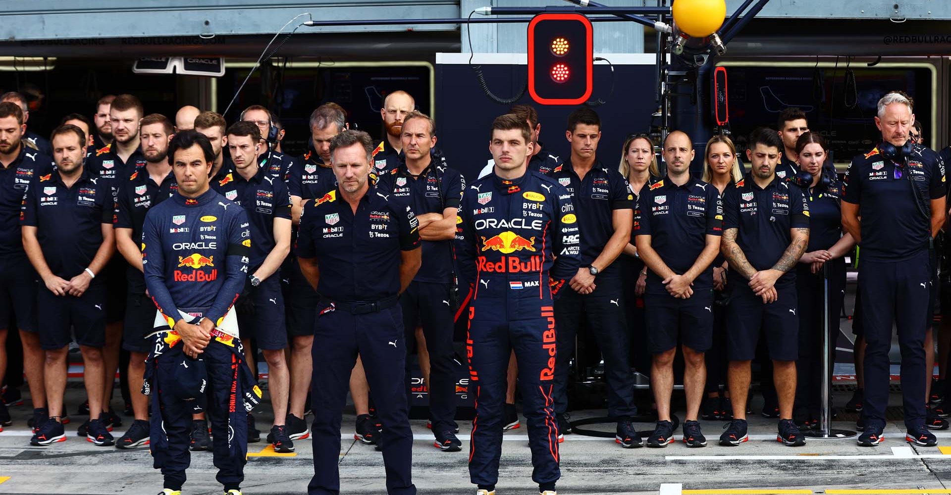 MONZA, ITALY - SEPTEMBER 09: Sergio Perez of Mexico and Oracle Red Bull Racing, Red Bull Racing Team Principal Christian Horner and Max Verstappen of the Netherlands and Oracle Red Bull Racing , are pictured as Formula 1 holds a minutes silence in mourning of Queen Elizabeth II prior to practice ahead of the F1 Grand Prix of Italy at Autodromo Nazionale Monza on September 09, 2022 in Monza, Italy. (Photo by Mark Thompson/Getty Images)