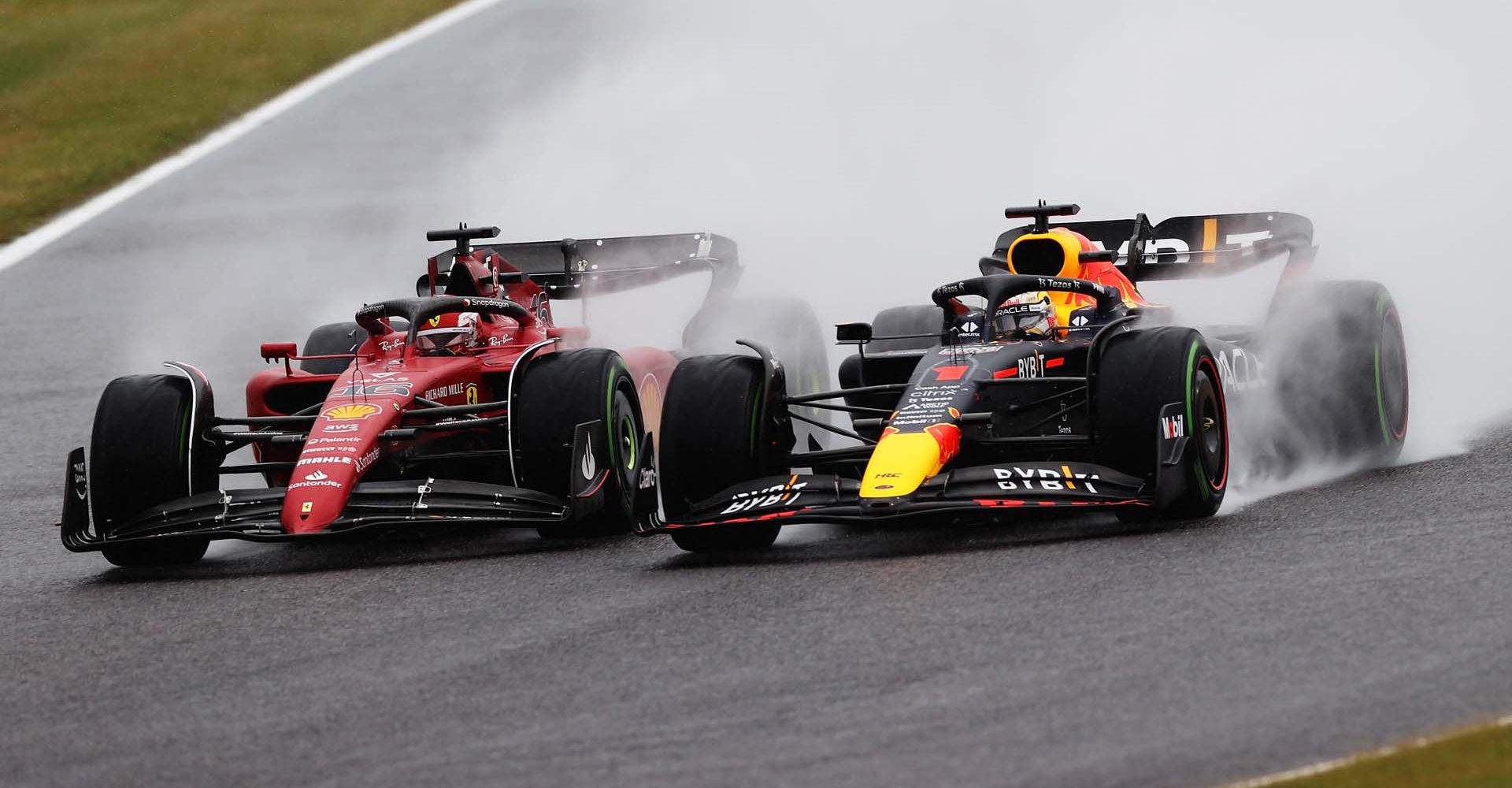 SUZUKA, JAPAN - OCTOBER 09: Max Verstappen of the Netherlands driving the (1) Oracle Red Bull Racing RB18 and Charles Leclerc of Monaco driving the (16) Ferrari F1-75 battle for track position at the start during the F1 Grand Prix of Japan at Suzuka International Racing Course on October 09, 2022 in Suzuka, Japan. (Photo by Peter Fox/Getty Images)