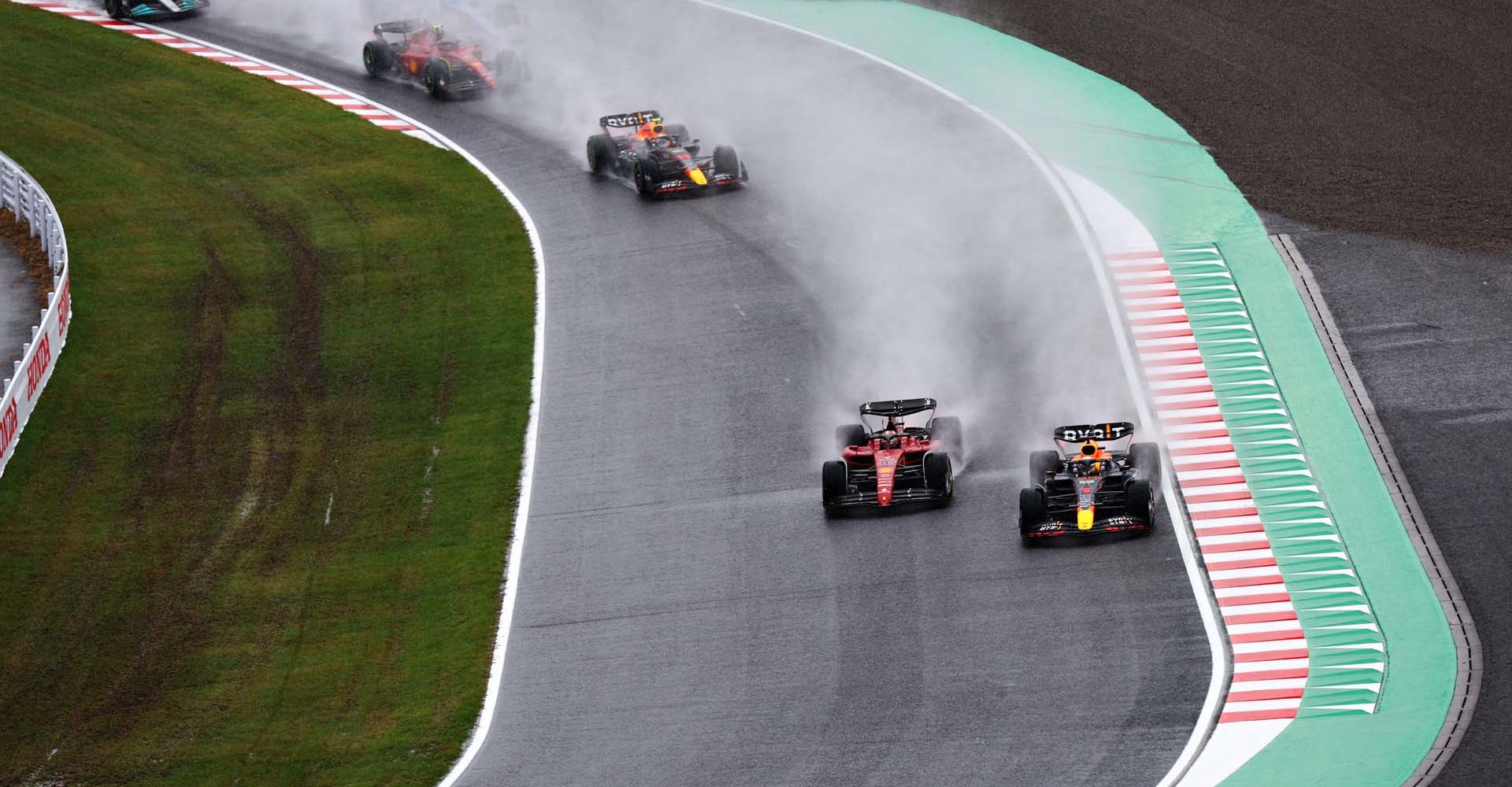 SUZUKA, JAPAN - OCTOBER 09: Max Verstappen of the Netherlands driving the (1) Oracle Red Bull Racing RB18 and Charles Leclerc of Monaco driving the (16) Ferrari F1-75 battle for track position on lap one during the F1 Grand Prix of Japan at Suzuka International Racing Course on October 09, 2022 in Suzuka, Japan. (Photo by Clive Rose/Getty Images)