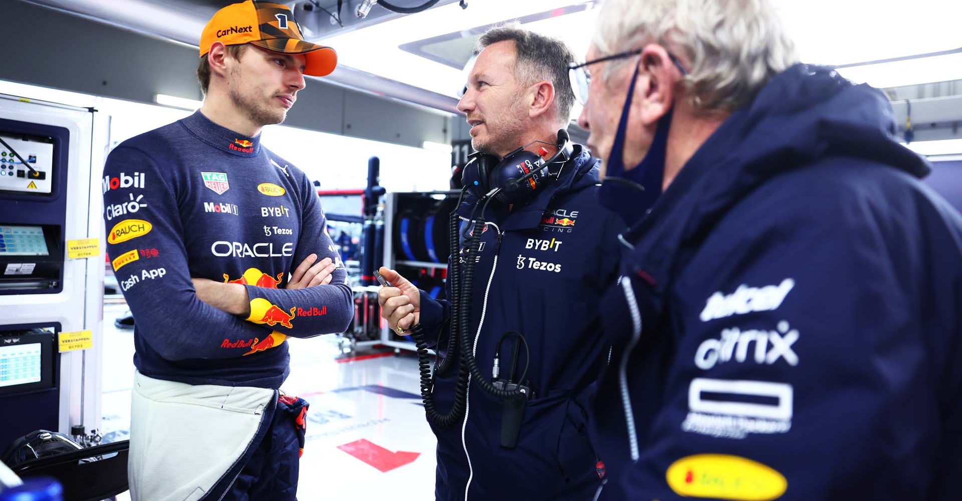 SUZUKA, JAPAN - OCTOBER 09: Max Verstappen of the Netherlands and Oracle Red Bull Racing talks with Red Bull Racing Team Principal Christian Horner and Red Bull Racing Team Consultant Dr Helmut Marko during a red flag delay during the F1 Grand Prix of Japan at Suzuka International Racing Course on October 09, 2022 in Suzuka, Japan. (Photo by Dan Istitene/Getty Images)