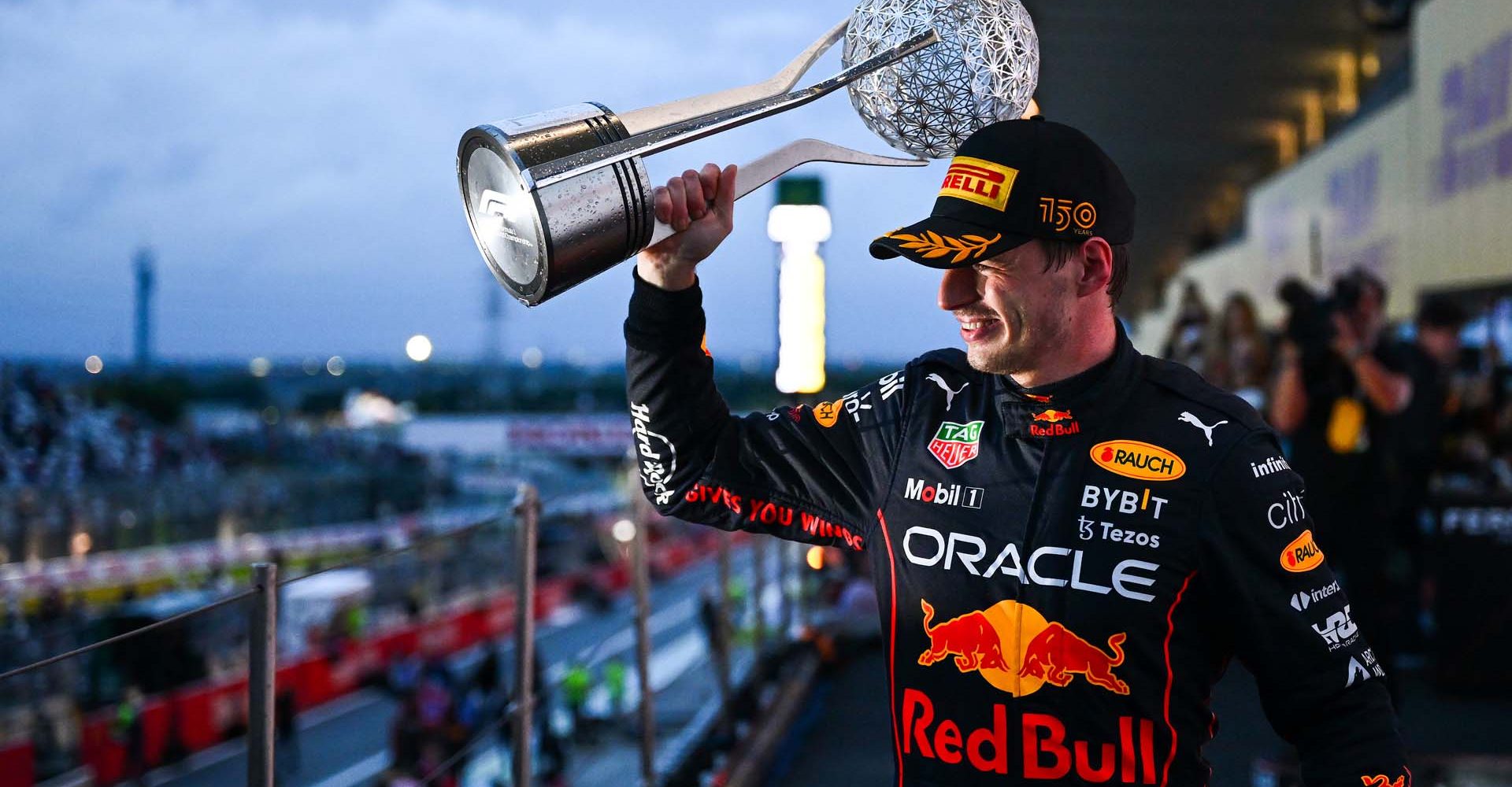 SUZUKA, JAPAN - OCTOBER 09: Race winner and 2022 F1 World Drivers Champion Max Verstappen of the Netherlands and Oracle Red Bull Racing celebrates on the podium during the F1 Grand Prix of Japan at Suzuka International Racing Course on October 09, 2022 in Suzuka, Japan. (Photo by Clive Mason/Getty Images)