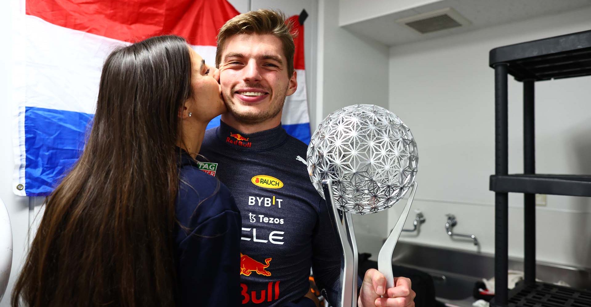 SUZUKA, JAPAN - OCTOBER 09: Race winner and 2022 F1 World Drivers Champion Max Verstappen of Netherlands and Oracle Red Bull Racing celebrates with Kelly Piquet and his trophy after the F1 Grand Prix of Japan at Suzuka International Racing Course on October 09, 2022 in Suzuka, Japan. (Photo by Mark Thompson/Getty Images )