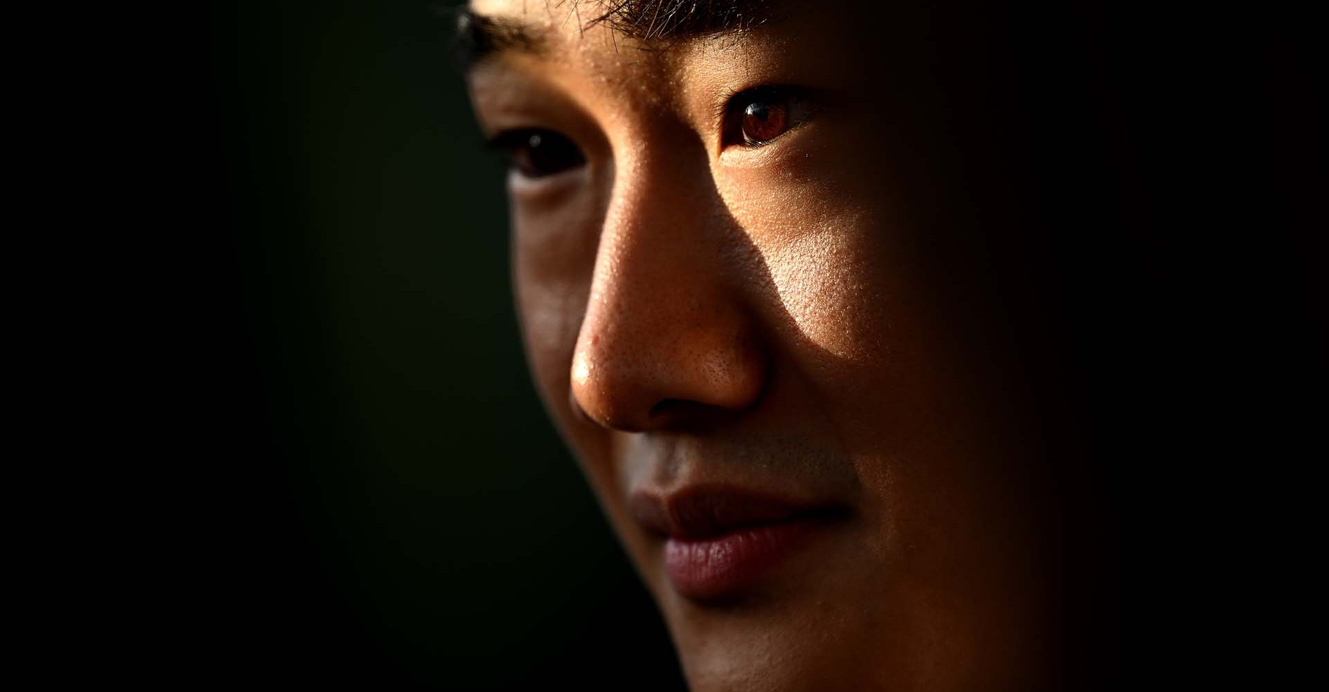 SUZUKA, JAPAN - OCTOBER 06: Yuki Tsunoda of Japan and Scuderia AlphaTauri looks on in the Paddock during previews ahead of the F1 Grand Prix of Japan at Suzuka International Racing Course on October 06, 2022 in Suzuka, Japan. (Photo by Clive Mason/Getty Images)