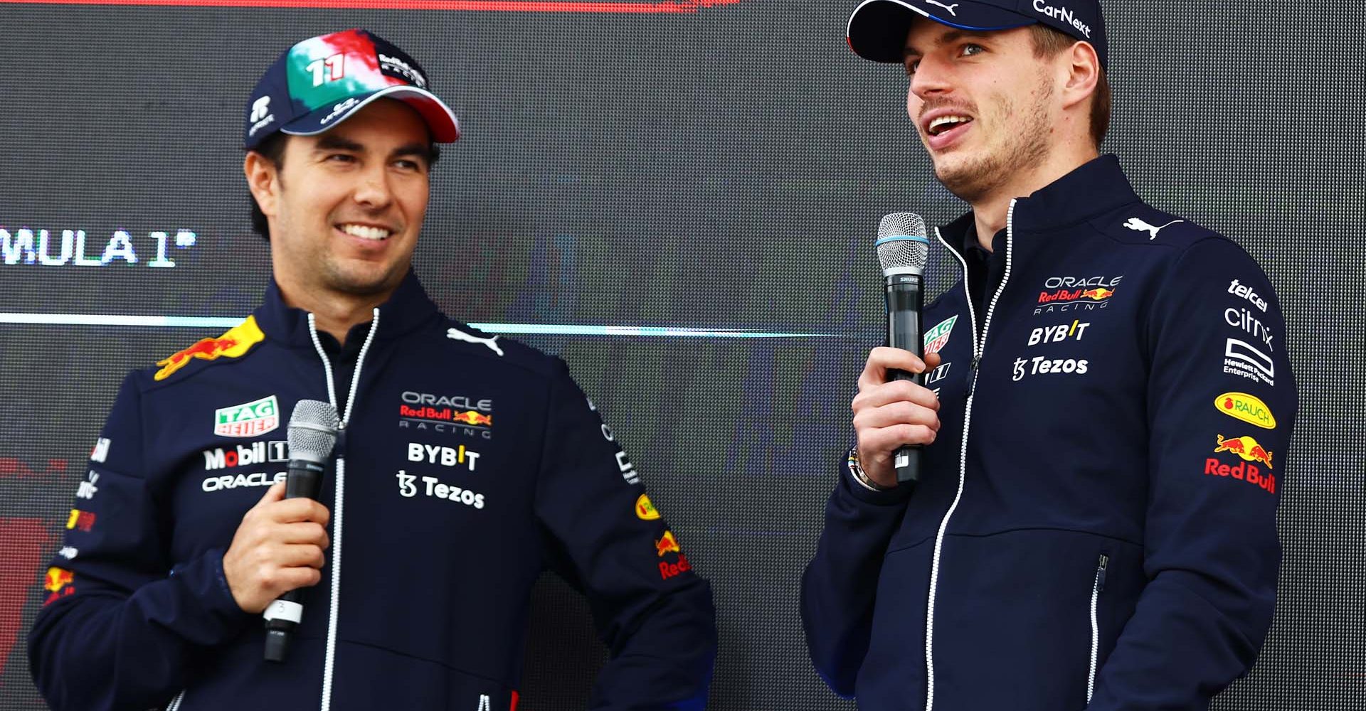 MEXICO CITY, MEXICO - OCTOBER 29: Sergio Perez of Mexico and Oracle Red Bull Racing and Max Verstappen of the Netherlands and Oracle Red Bull Racing talk to the crowd on the fan stage prior to final practice ahead of the F1 Grand Prix of Mexico at Autodromo Hermanos Rodriguez on October 29, 2022 in Mexico City, Mexico. (Photo by Mark Thompson/Getty Images )