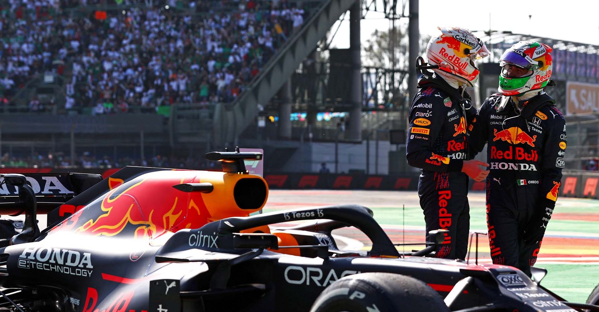 MEXICO CITY, MEXICO - NOVEMBER 07: Race winner Max Verstappen of Netherlands and Red Bull Racing and third placed Sergio Perez of Mexico and Red Bull Racing celebrate in parc ferme during the F1 Grand Prix of Mexico at Autodromo Hermanos Rodriguez on November 07, 2021 in Mexico City, Mexico. (Photo by Mark Thompson/Getty Images)