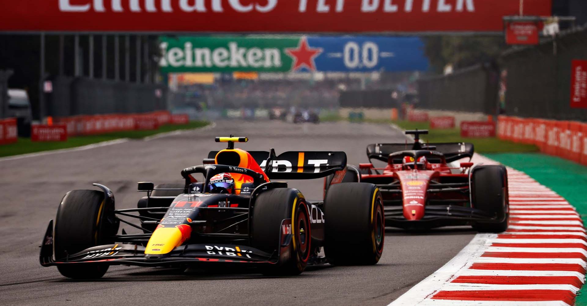 MEXICO CITY, MEXICO - OCTOBER 30: Sergio Perez of Mexico driving the (11) Oracle Red Bull Racing RB18 leads Charles Leclerc of Monaco driving (16) the Ferrari F1-75 on track during the F1 Grand Prix of Mexico at Autodromo Hermanos Rodriguez on October 30, 2022 in Mexico City, Mexico. (Photo by Chris Graythen/Getty Images)