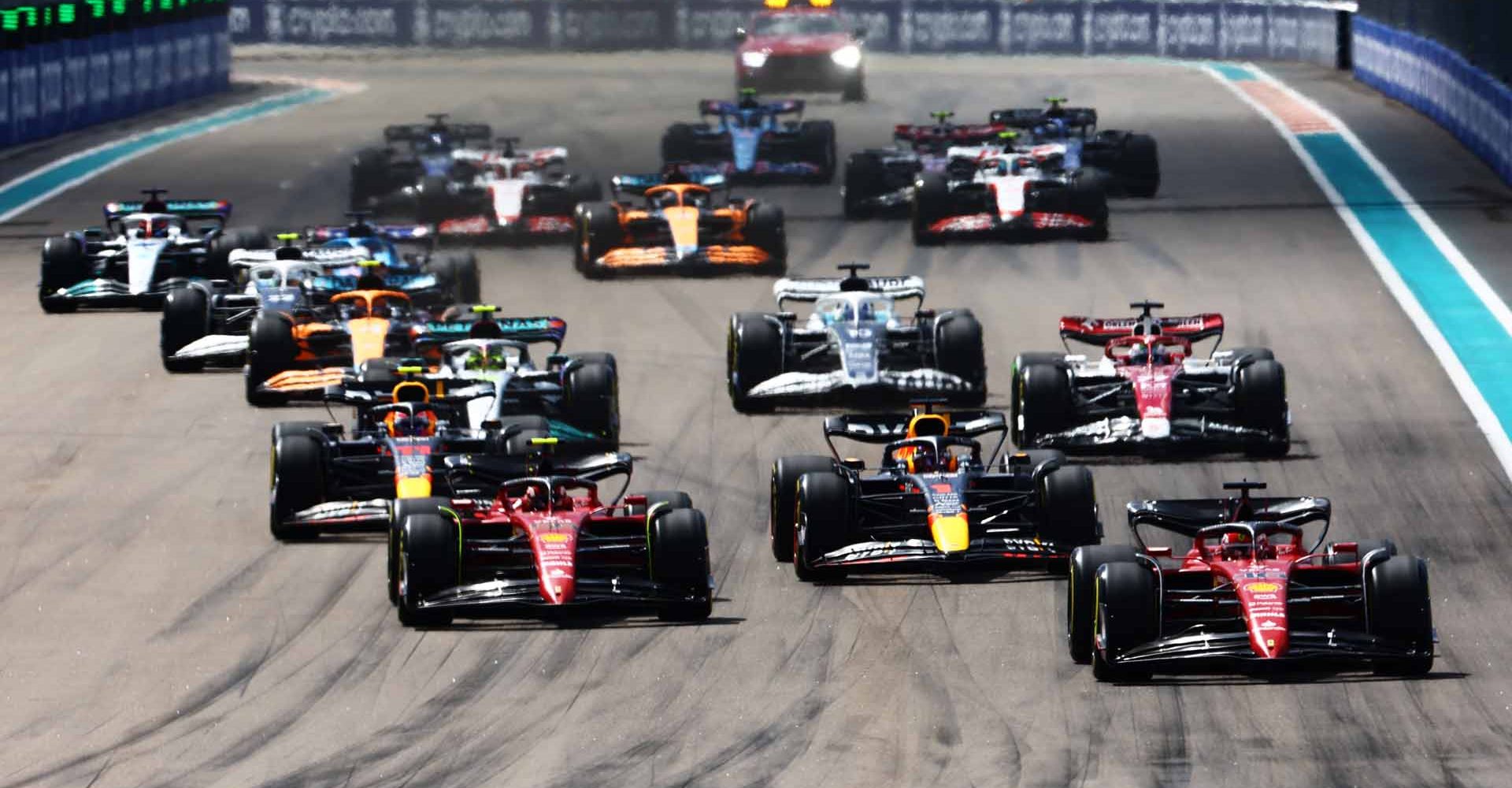 MIAMI, FLORIDA - MAY 08: Charles Leclerc of Monaco driving (16) the Ferrari F1-75 leads Max Verstappen of the Netherlands driving the (1) Oracle Red Bull Racing RB18, Carlos Sainz of Spain driving (55) the Ferrari F1-75 and the rest of the field into turn one at the start during the F1 Grand Prix of Miami at the Miami International Autodrome on May 08, 2022 in Miami, Florida. (Photo by Mark Thompson/Getty Images)