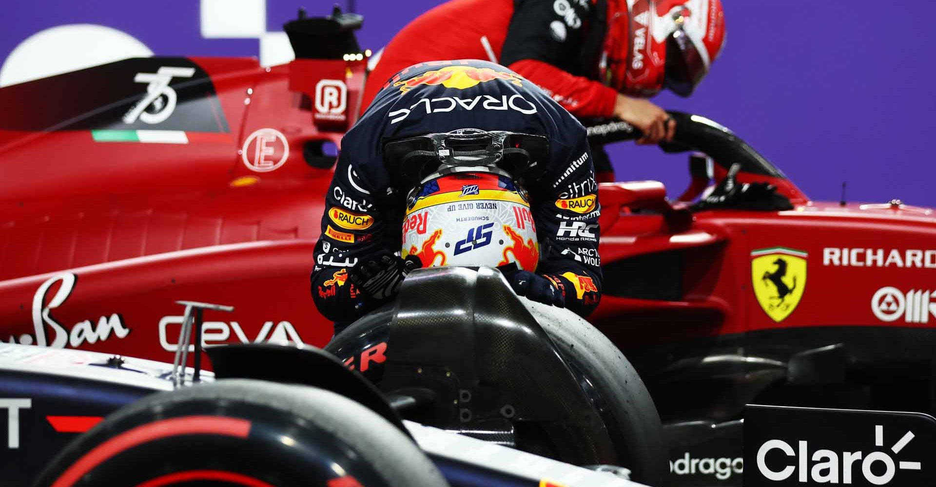 JEDDAH, SAUDI ARABIA - MARCH 26: Pole position qualifier Sergio Perez of Mexico and Oracle Red Bull Racing celebrates as Second placed qualifier Charles Leclerc of Monaco and Ferrari climbs from his car in parc ferme during qualifying ahead of the F1 Grand Prix of Saudi Arabia at the Jeddah Corniche Circuit on March 26, 2022 in Jeddah, Saudi Arabia. (Photo by Lars Baron/Getty Images)