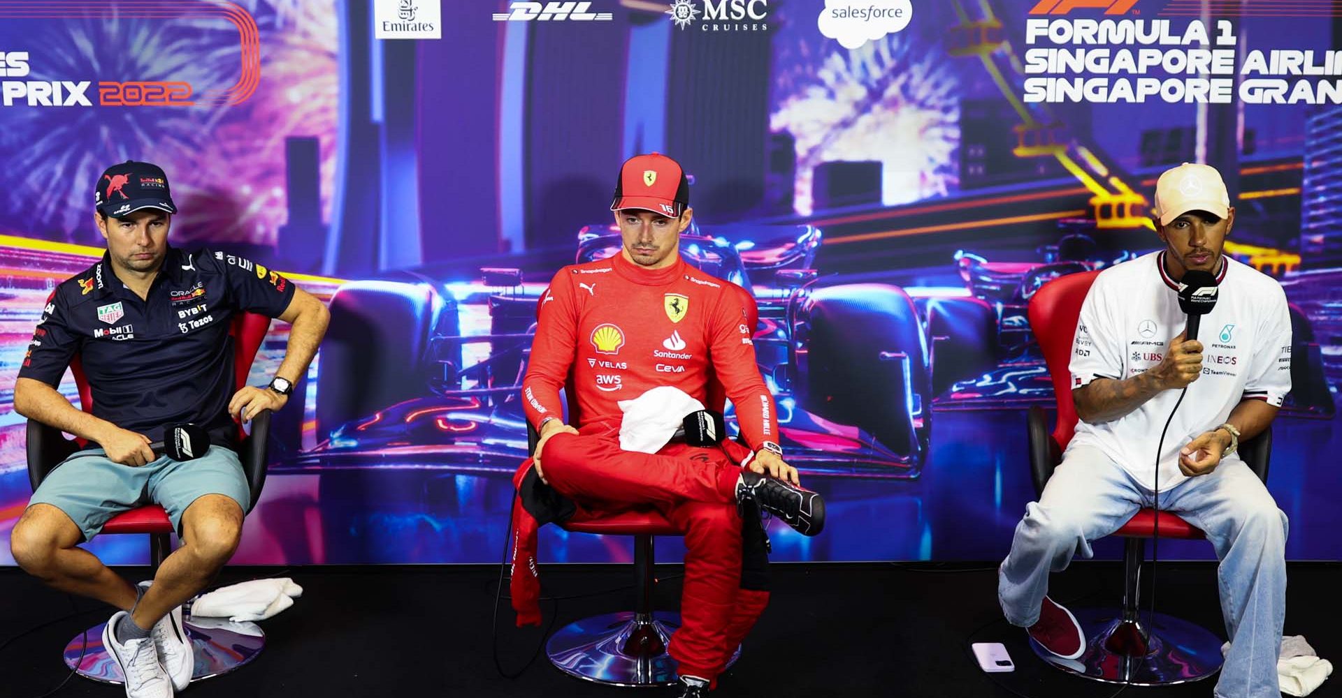 SINGAPORE, SINGAPORE - OCTOBER 01: Pole position qualifier Charles Leclerc of Monaco and Ferrari (C), Second placed qualifier Sergio Perez of Mexico and Oracle Red Bull Racing (L) and Third placed qualifier Lewis Hamilton of Great Britain and Mercedes (R) attend the press conference after qualifying ahead of the F1 Grand Prix of Singapore at Marina Bay Street Circuit on October 01, 2022 in Singapore, Singapore. (Photo by Dan Istitene/Getty Images)