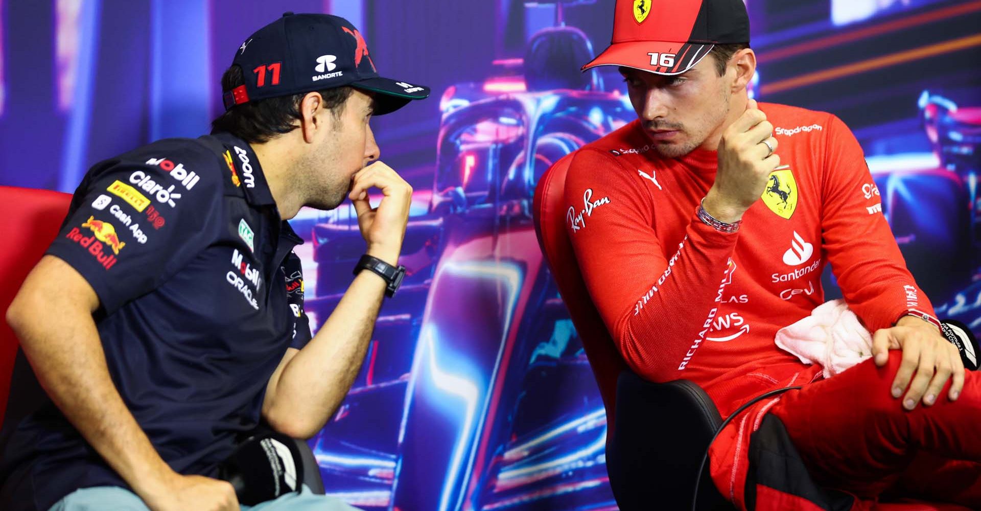 SINGAPORE, SINGAPORE - OCTOBER 01: Pole position qualifier Charles Leclerc of Monaco and Ferrari and Second placed qualifier Sergio Perez of Mexico and Oracle Red Bull Racing talk in the press conference after qualifying ahead of the F1 Grand Prix of Singapore at Marina Bay Street Circuit on October 01, 2022 in Singapore, Singapore. (Photo by Dan Istitene/Getty Images)