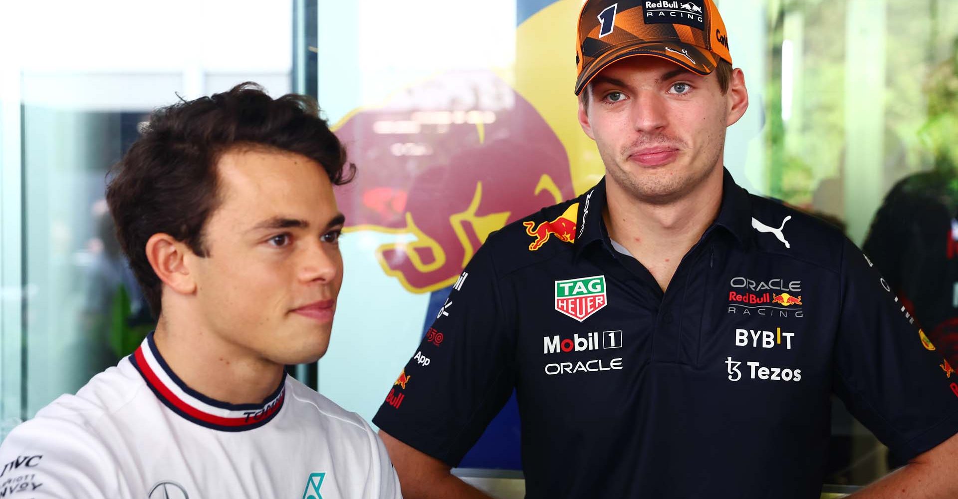 SINGAPORE, SINGAPORE - OCTOBER 02: Max Verstappen of the Netherlands and Oracle Red Bull Racing and Nyck de Vries of Netherlands, Mercedes Test and Reserve Driver talk in the Paddock prior to the F1 Grand Prix of Singapore at Marina Bay Street Circuit on October 02, 2022 in Singapore, Singapore. (Photo by Mark Thompson/Getty Images,)