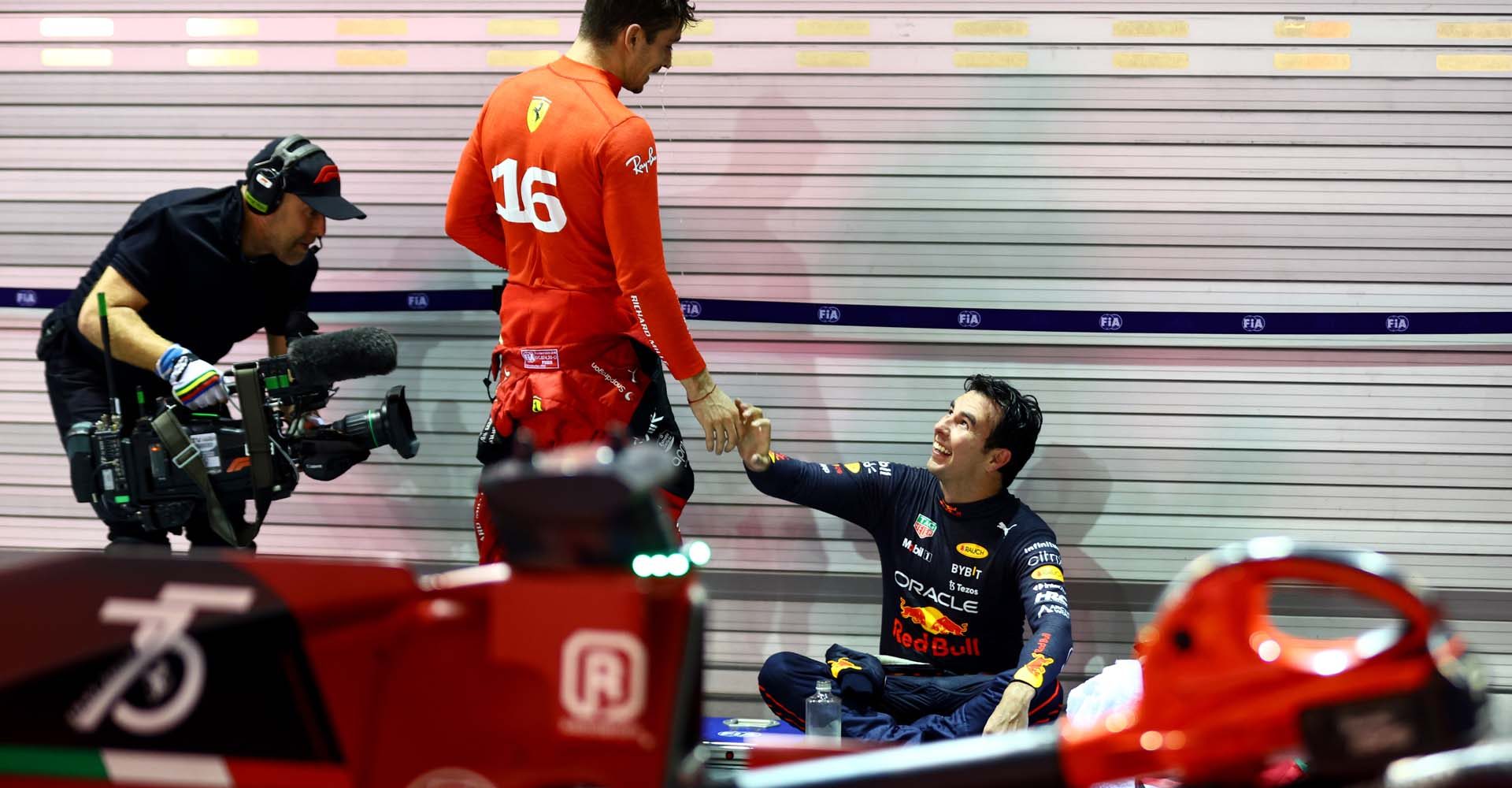 SINGAPORE, SINGAPORE - OCTOBER 02: Race winner Sergio Perez of Mexico and Oracle Red Bull Racing and Second placed Charles Leclerc of Monaco and Ferrari celebrate in parc ferme during the F1 Grand Prix of Singapore at Marina Bay Street Circuit on October 02, 2022 in Singapore, Singapore. (Photo by Mark Thompson/Getty Images,)