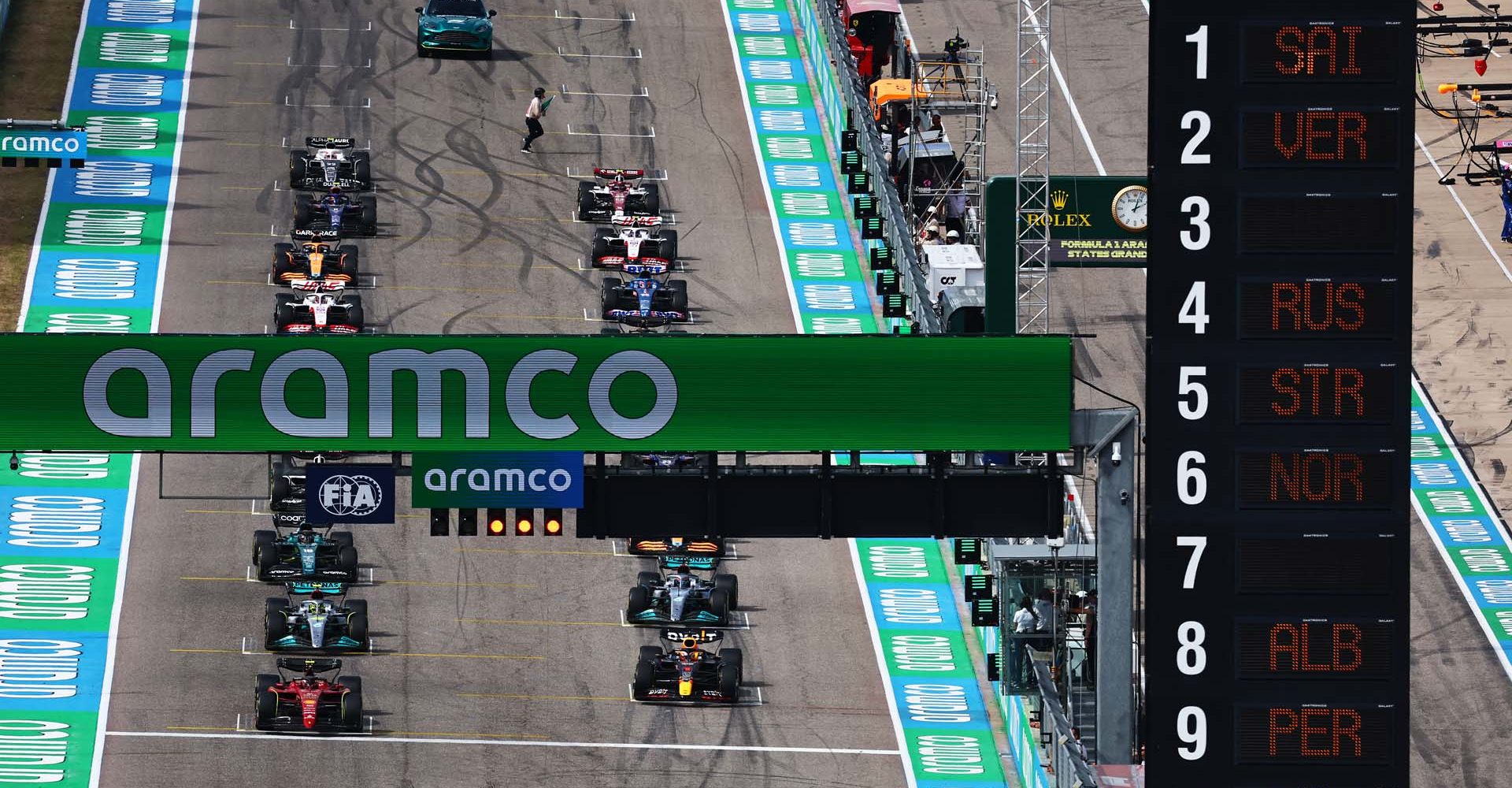 AUSTIN, TEXAS - OCTOBER 23: Max Verstappen of the Netherlands driving the (1) Oracle Red Bull Racing RB18 and Carlos Sainz of Spain driving (55) the Ferrari F1-75 wait on the grid for the start during the F1 Grand Prix of USA at Circuit of The Americas on October 23, 2022 in Austin, Texas. (Photo by Mark Thompson/Getty Images)