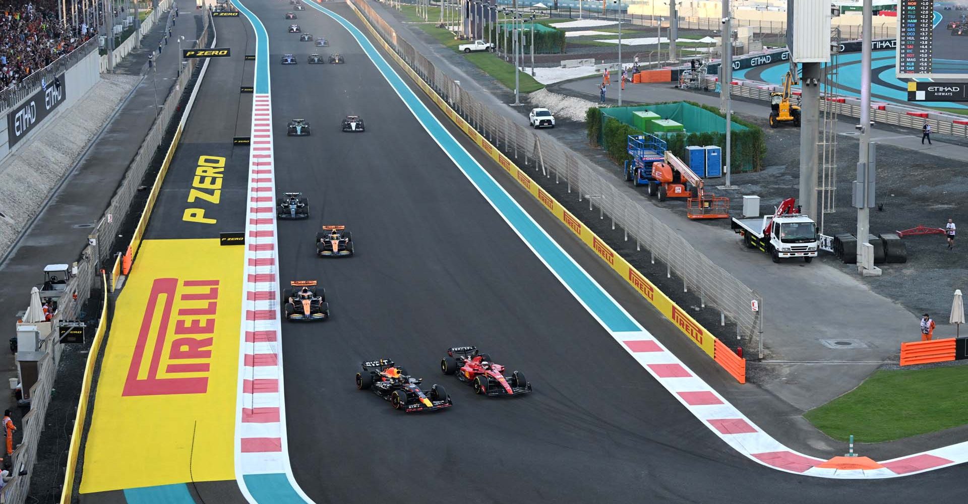 YAS MARINA CIRCUIT, UNITED ARAB EMIRATES - NOVEMBER 26: Max Verstappen, Red Bull Racing RB19 battles with Charles Leclerc, Ferrari SF-23 during the Abu Dhabi GP at Yas Marina Circuit on Sunday November 26, 2023 in Abu Dhabi, United Arab Emirates. (Photo by Simon Galloway / LAT Images)