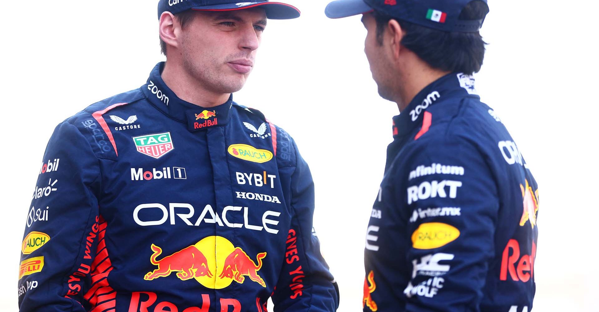 ABU DHABI, UNITED ARAB EMIRATES - NOVEMBER 26: Max Verstappen of the Netherlands and Oracle Red Bull Racing and Sergio Perez of Mexico and Oracle Red Bull Racing talk at the Red Bull Racing Team Photo prior to the F1 Grand Prix of Abu Dhabi at Yas Marina Circuit on November 26, 2023 in Abu Dhabi, United Arab Emirates. (Photo by Clive Rose/Getty Images) // Getty Images / Red Bull Content Pool // SI202311260013 // Usage for editorial use only //