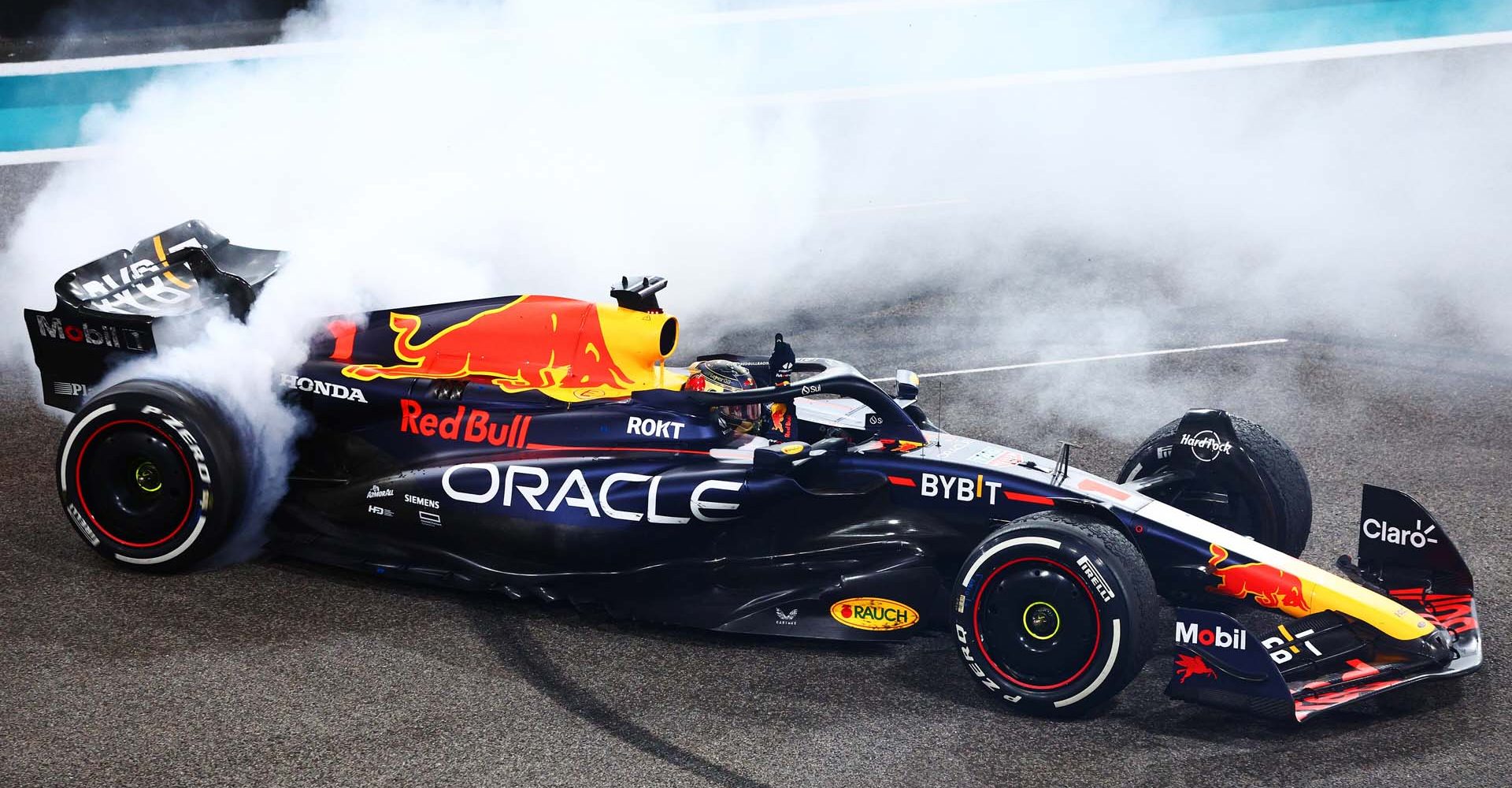 ABU DHABI, UNITED ARAB EMIRATES - NOVEMBER 26: Race winner Max Verstappen of the Netherlands driving the (1) Oracle Red Bull Racing RB19 performs donuts on track during the F1 Grand Prix of Abu Dhabi at Yas Marina Circuit on November 26, 2023 in Abu Dhabi, United Arab Emirates. (Photo by Clive Rose/Getty Images) // Getty Images / Red Bull Content Pool // SI202311260242 // Usage for editorial use only //