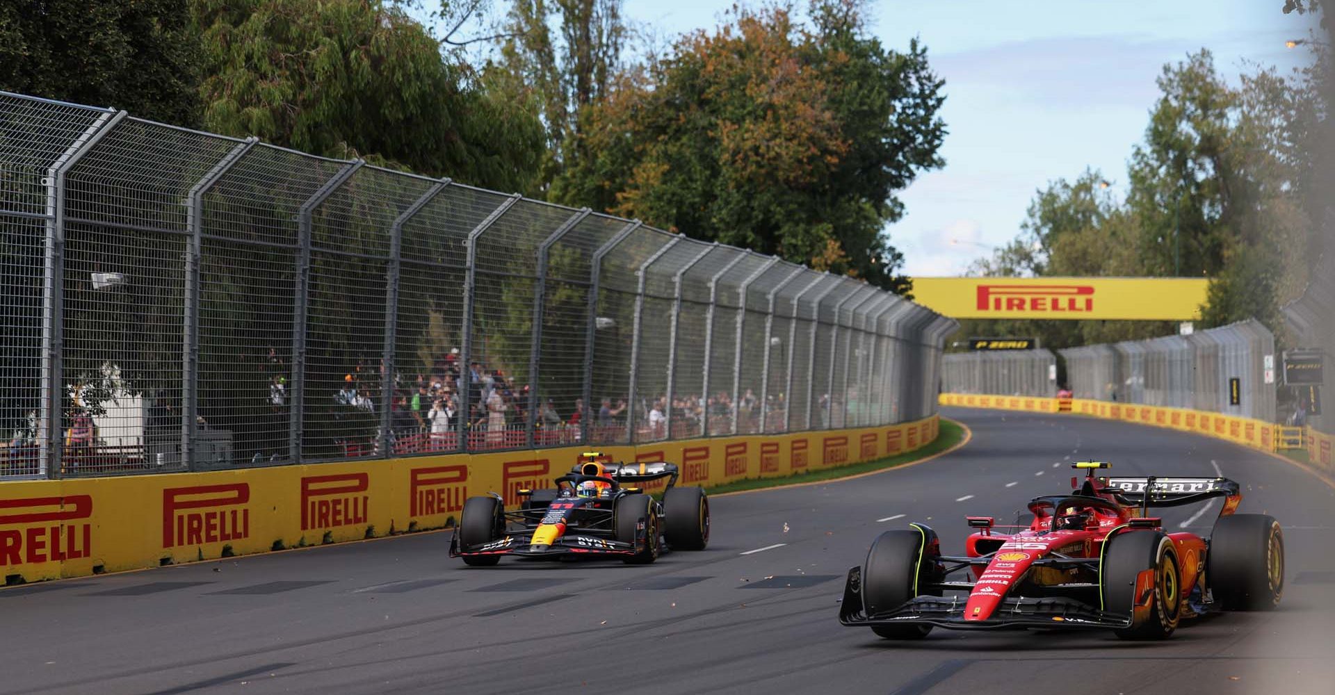 MELBOURNE GRAND PRIX CIRCUIT, AUSTRALIA - MARCH 31: Carlos Sainz, Ferrari SF-23, leads Sergio Perez, Red Bull Racing RB19 during the Australian GP at Melbourne Grand Prix Circuit on Friday March 31, 2023 in Melbourne, Australia. (Photo by Lionel Ng / LAT Images)