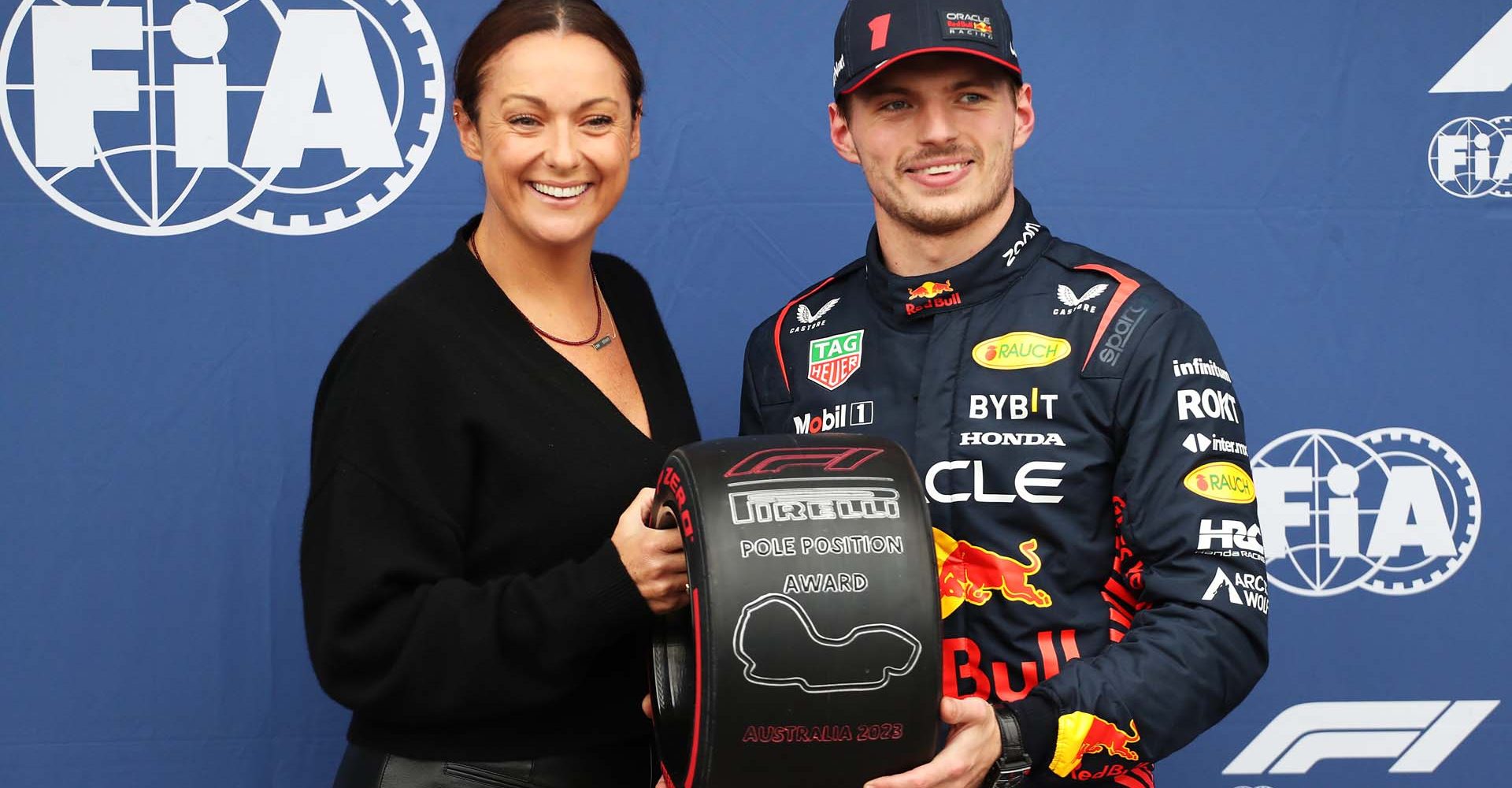 MELBOURNE, AUSTRALIA - APRIL 01: Pole position qualifier Max Verstappen of the Netherlands and Oracle Red Bull Racing is presented with the Pirelli Pole Position trophy by Celeste Barber in parc ferme during qualifying ahead of the F1 Grand Prix of Australia at Albert Park Grand Prix Circuit on April 01, 2023 in Melbourne, Australia. (Photo by Peter Fox/Getty Images)