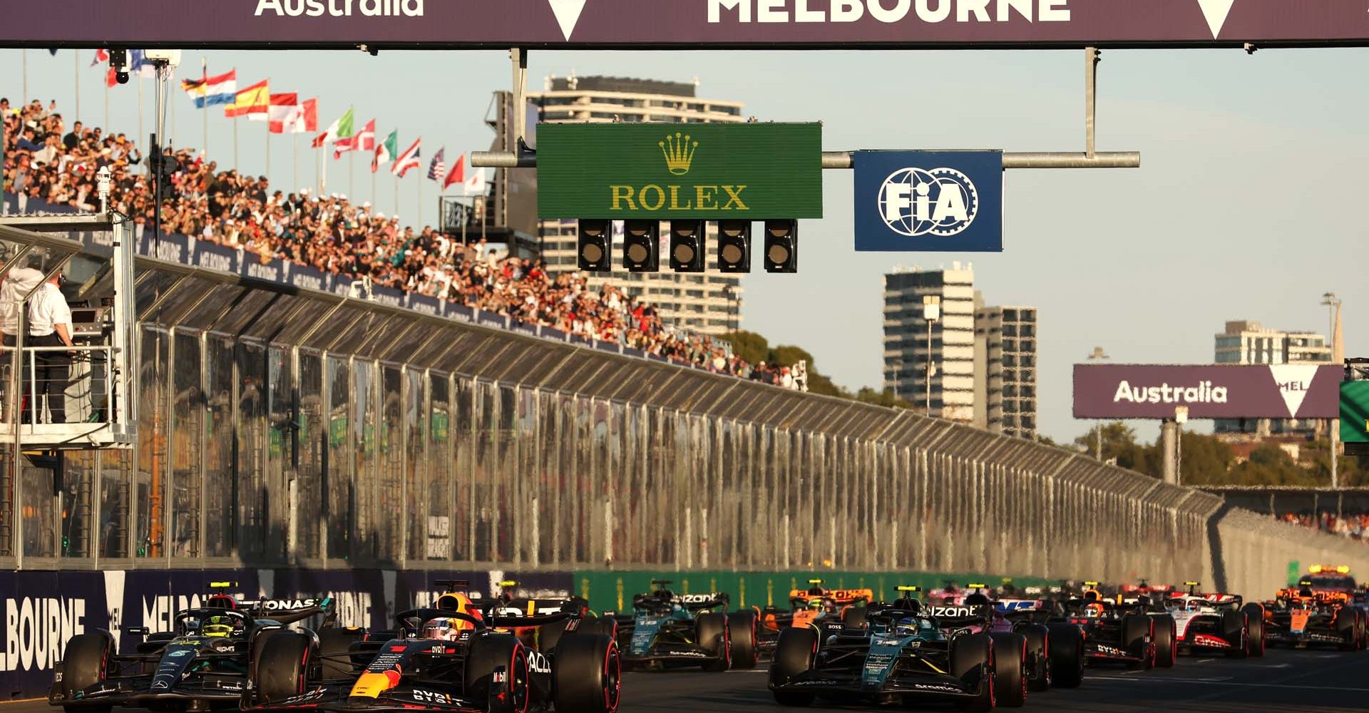 MELBOURNE, AUSTRALIA - APRIL 02: Race winner Max Verstappen of the Netherlands driving the (1) Oracle Red Bull Racing RB19 leads Second placed Lewis Hamilton of Great Britain driving the (44) Mercedes AMG Petronas F1 Team W14, Third placed Fernando Alonso of Spain driving the (14) Aston Martin AMR23 Mercedes and the rest of the field at the second restart during the F1 Grand Prix of Australia at Albert Park Grand Prix Circuit on April 02, 2023 in Melbourne, Australia. (Photo by Robert Cianflone/Getty Images)