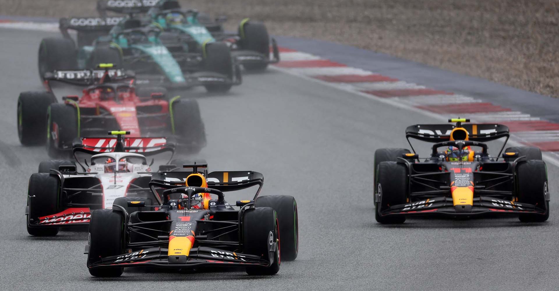 SPIELBERG, AUSTRIA - JULY 01: Max Verstappen of the Netherlands driving the (1) Oracle Red Bull Racing RB19 leads Sergio Perez of Mexico driving the (11) Oracle Red Bull Racing RB19, Nico Hulkenberg of Germany driving the (27) Haas F1 VF-23 Ferrari and the rest of the field at the start during the Sprint ahead of the F1 Grand Prix of Austria at Red Bull Ring on July 01, 2023 in Spielberg, Austria. (Photo by Lars Baron/Getty Images)