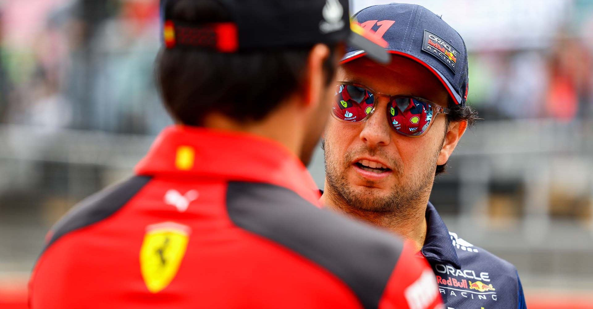 BAKU, AZERBAIJAN - APRIL 30: Sergio Perez of Mexico and Oracle Red Bull Racing talks with Carlos Sainz of Spain and Ferrari prior to the F1 Grand Prix of Azerbaijan at Baku City Circuit on April 30, 2023 in Baku, Azerbaijan. (Photo by Mark Thompson/Getty Images)