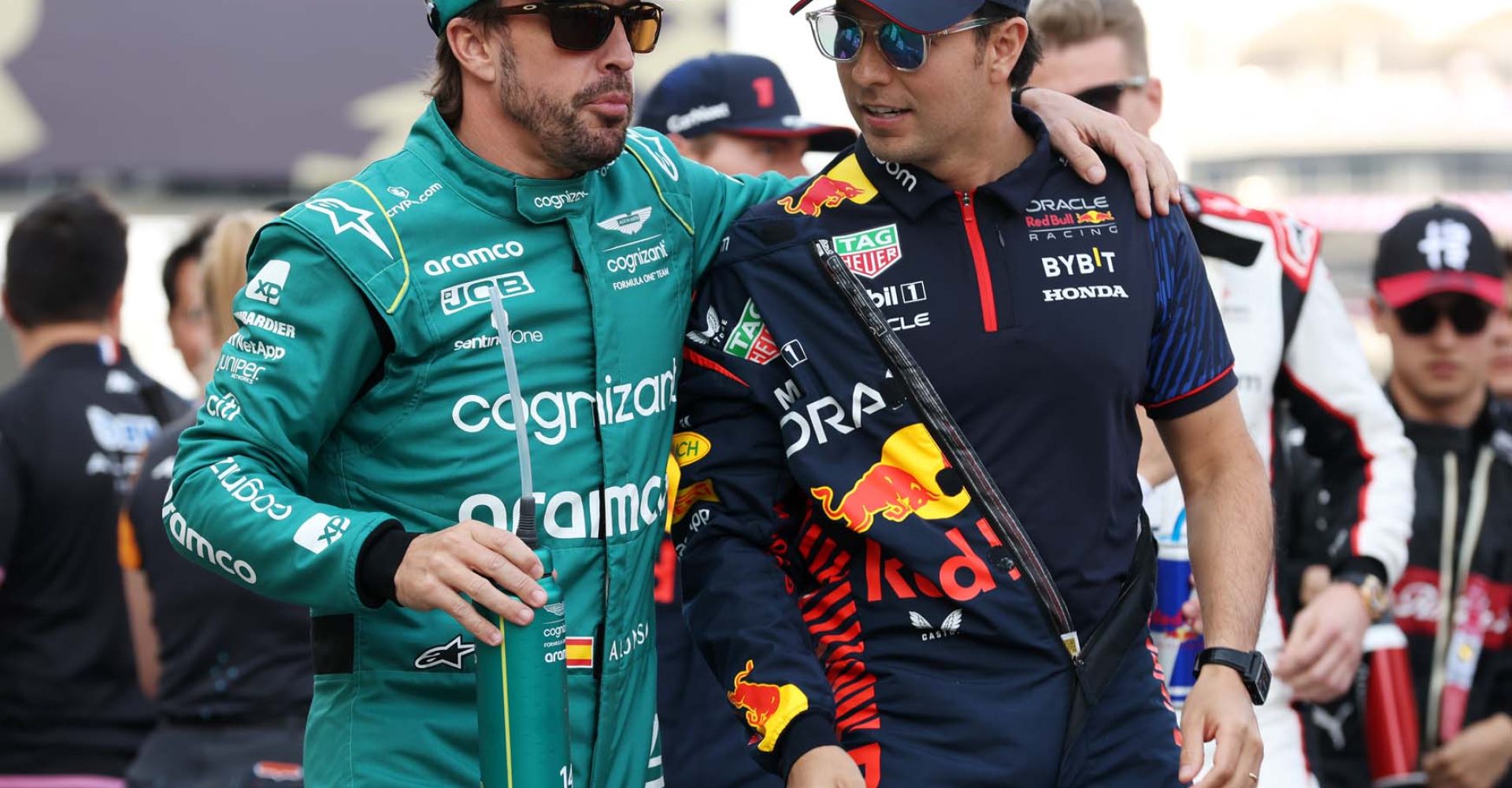 BAHRAIN, BAHRAIN - MARCH 05: Sergio Perez of Mexico and Oracle Red Bull Racing talks with Fernando Alonso of Spain and Aston Martin F1 Team on the drivers parade prior to the F1 Grand Prix of Bahrain at Bahrain International Circuit on March 05, 2023 in Bahrain, Bahrain. (Photo by Lars Baron/Getty Images)