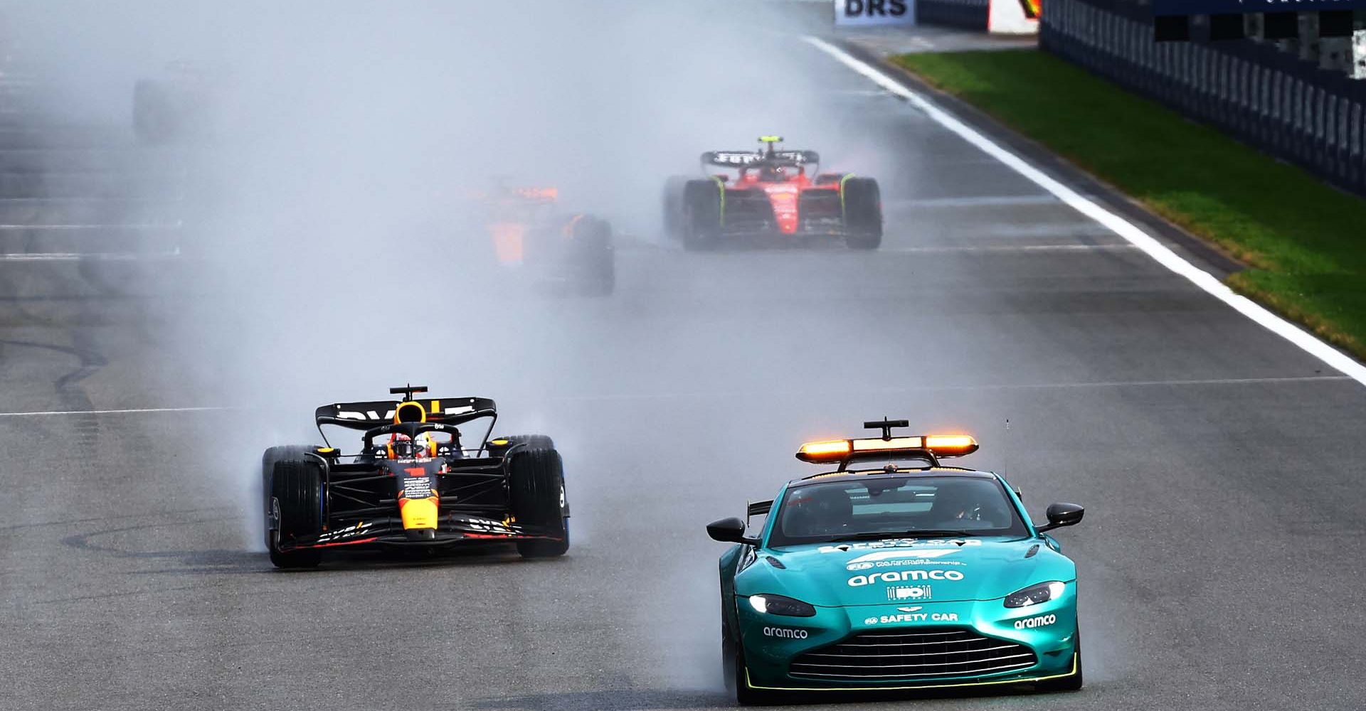 SPA, BELGIUM - JULY 29: The FIA Safety Car leads Max Verstappen of the Netherlands driving the (1) Oracle Red Bull Racing RB19 and the rest of the field during the Sprint ahead of the F1 Grand Prix of Belgium at Circuit de Spa-Francorchamps on July 29, 2023 in Spa, Belgium. (Photo by Mark Thompson/Getty Images)