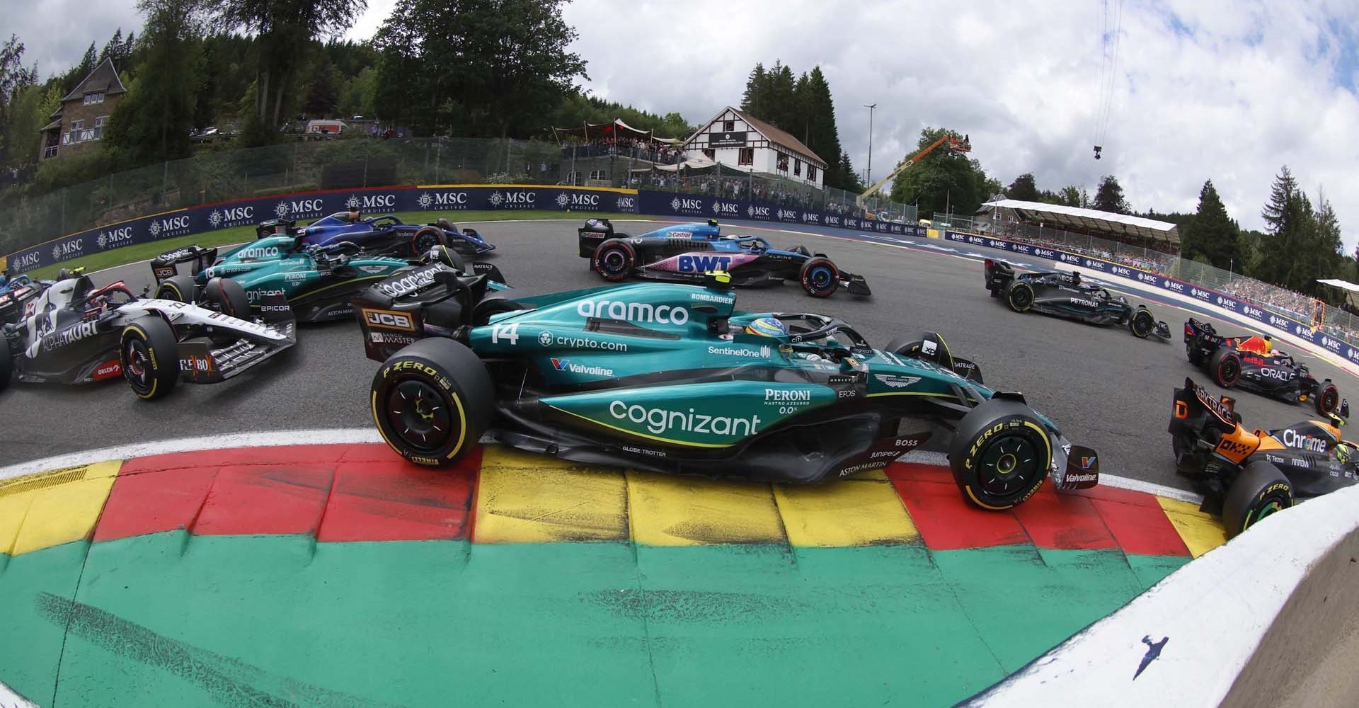 CIRCUIT DE SPA FRANCORCHAMPS, BELGIUM - JULY 30: Fernando Alonso, Aston Martin AMR23, leads Lance Stroll, Aston Martin AMR23, and Yuki Tsunoda, AlphaTauri AT04, at the start during the Belgian GP at Circuit de Spa Francorchamps on Sunday July 30, 2023 in Spa, Belgium. (Photo by Steven Tee / LAT Images)